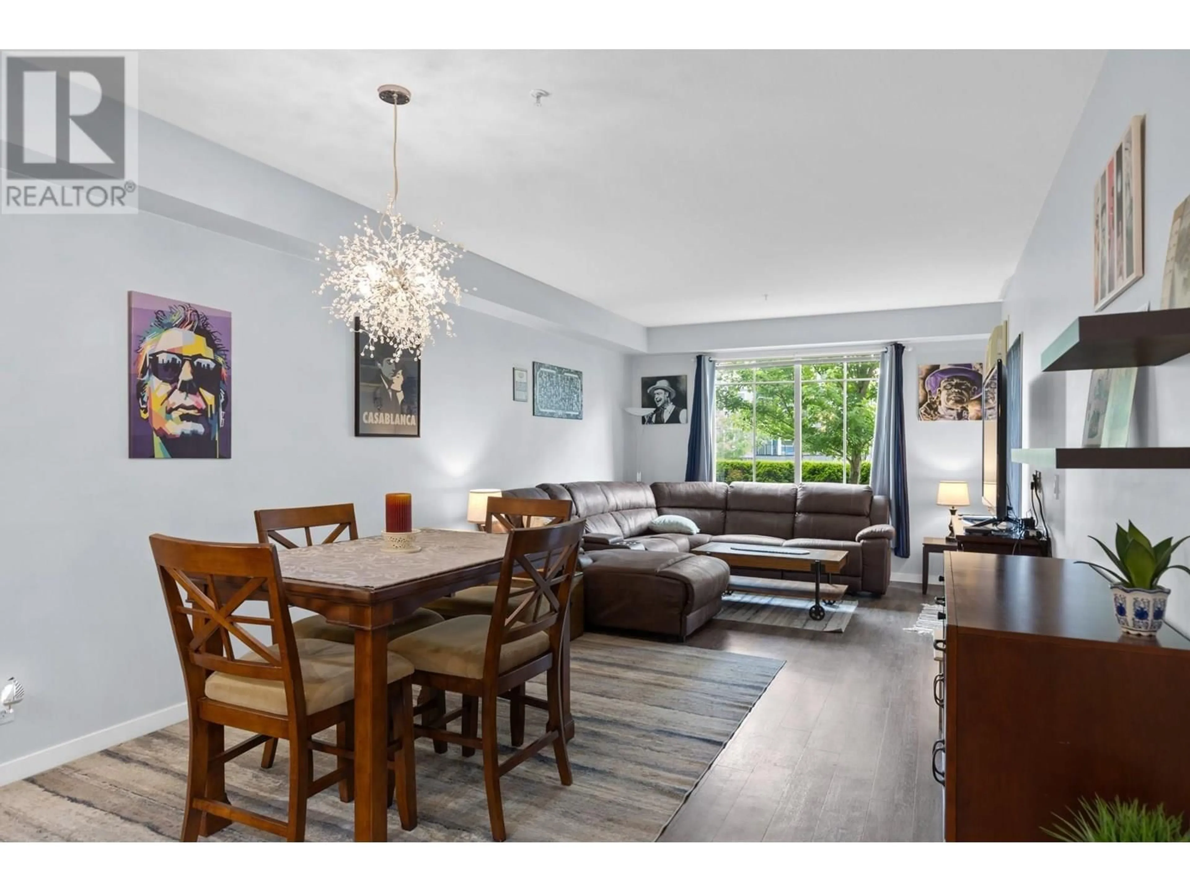 Living room with furniture, wood/laminate floor for 109 - 3733 CASORSO ROAD, Kelowna British Columbia V1W5E3
