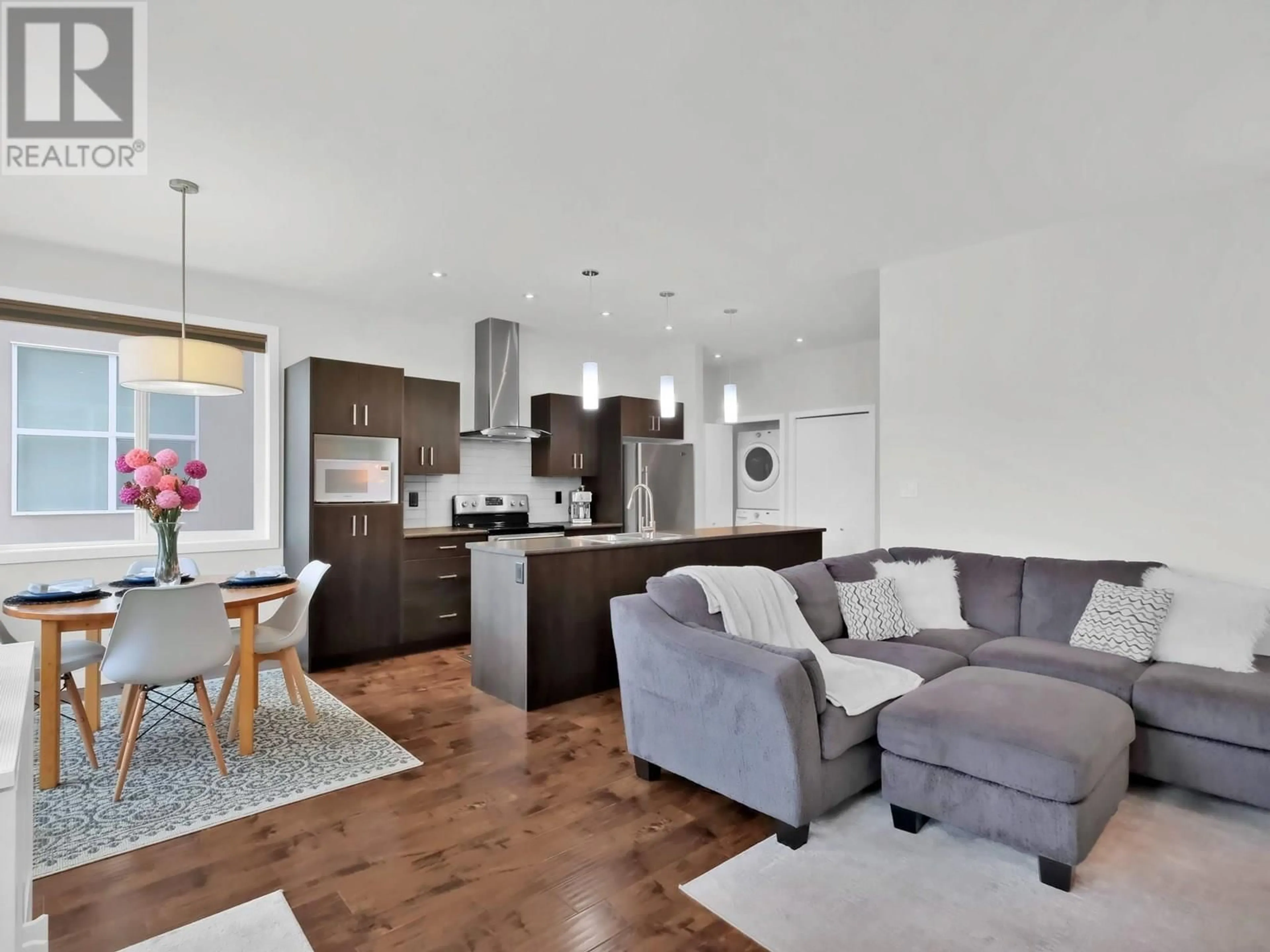 Open concept kitchen, wood/laminate floor for 101 - 134 COSSAR AVENUE, Penticton British Columbia V2A2V4