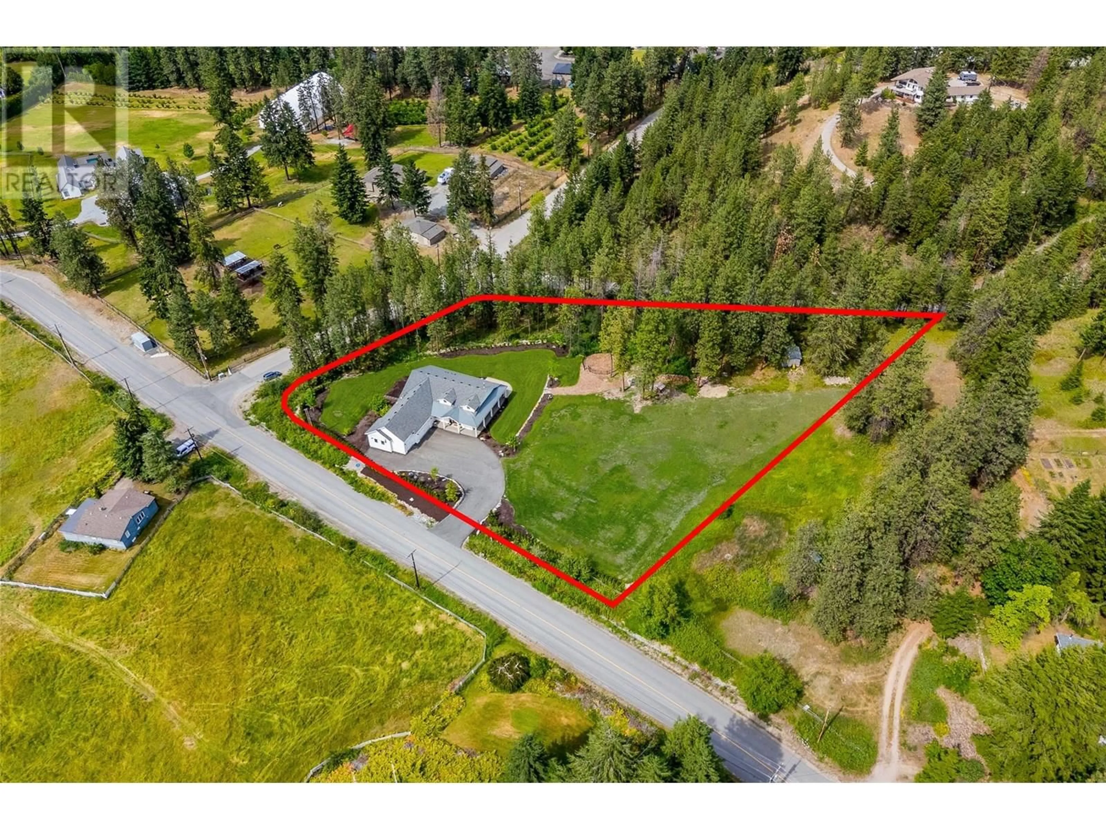 A pic from outside/outdoor area/front of a property/back of a property/a pic from drone, street for 4135 JUNE SPRINGS ROAD, Kelowna British Columbia V1W4C9