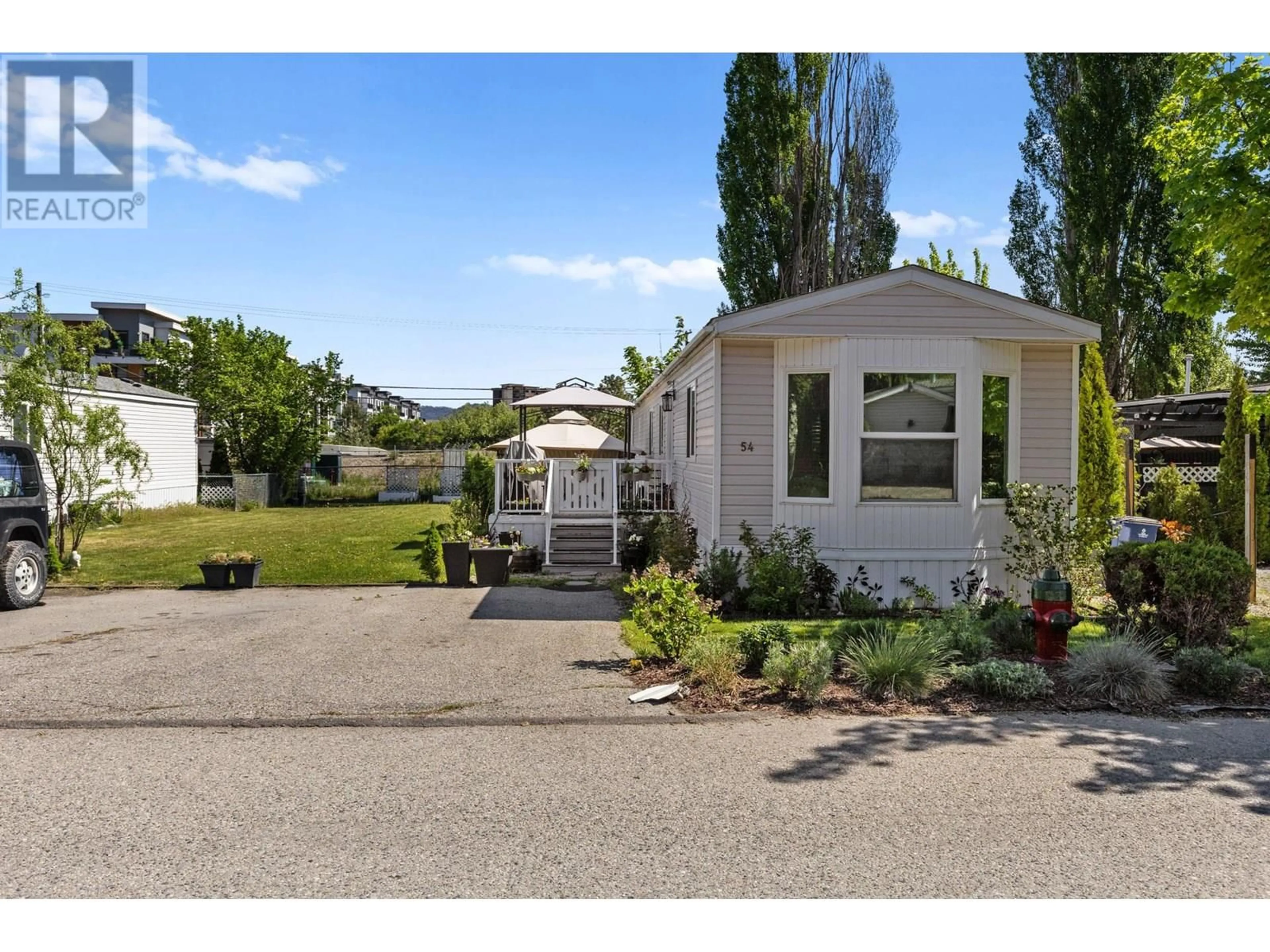 Home with vinyl exterior material, street for 54 - 1525 WESTSIDE ROAD SOUTH, Kelowna British Columbia V1Z3Y3