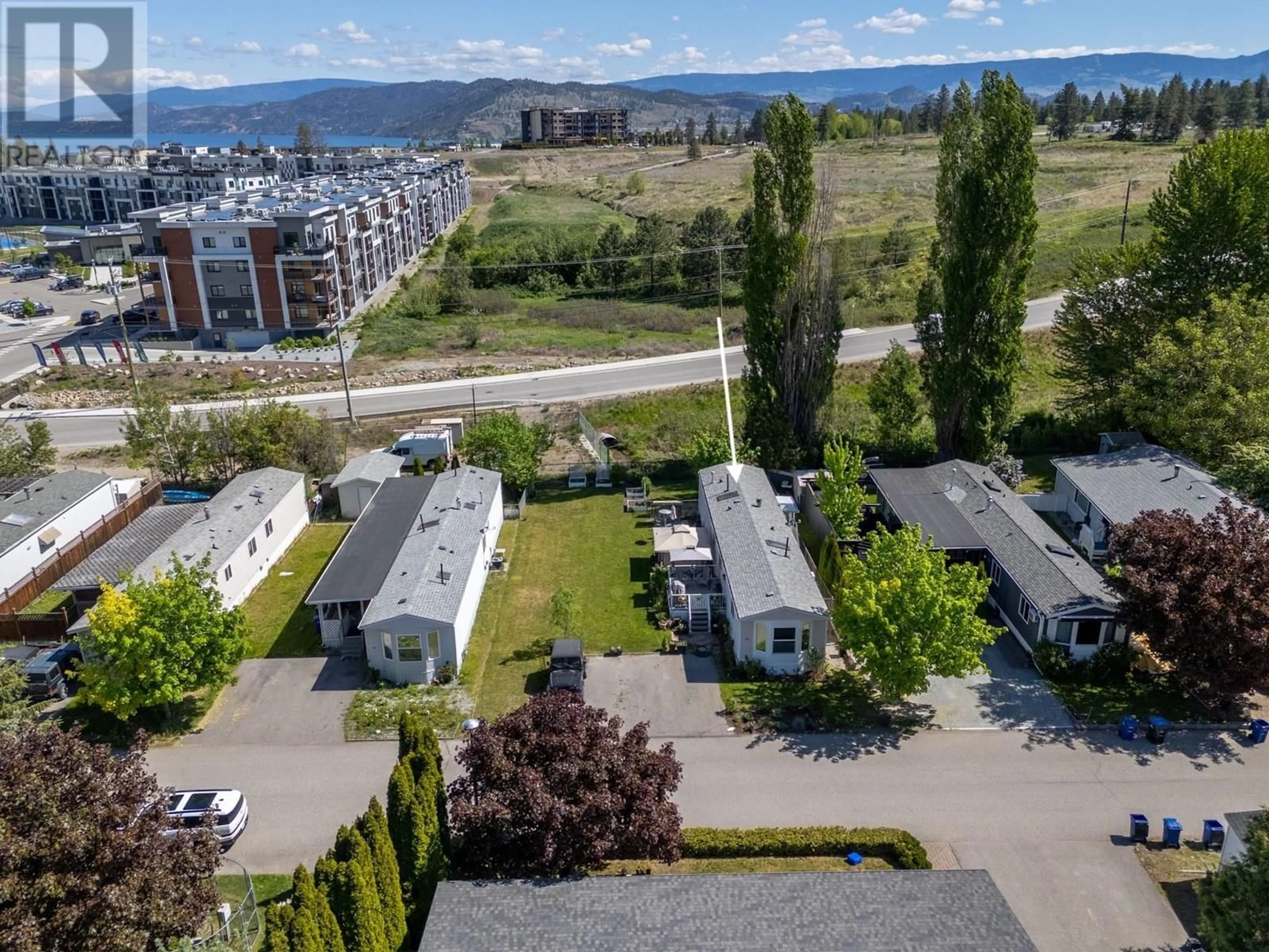 A pic from outside/outdoor area/front of a property/back of a property/a pic from drone, mountain view for 54 - 1525 WESTSIDE ROAD SOUTH, Kelowna British Columbia V1Z3Y3