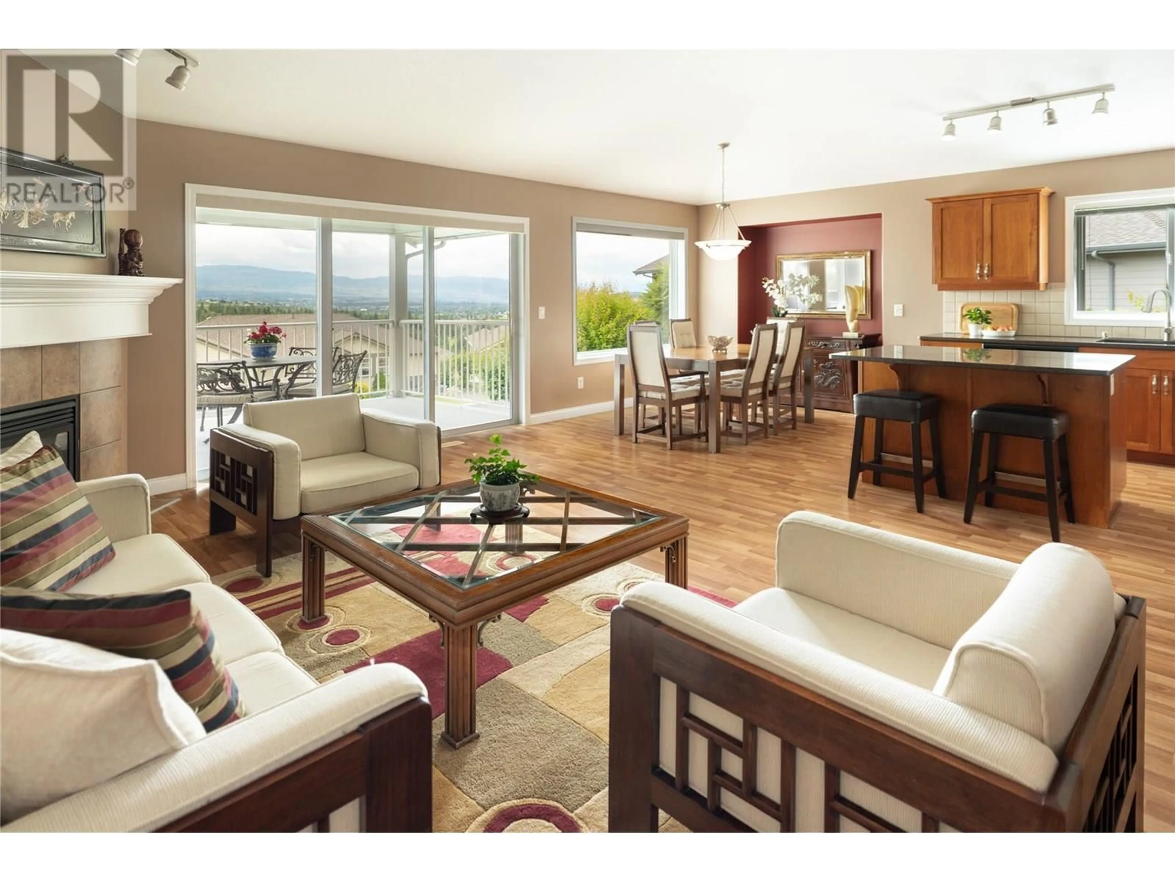 Living room with furniture, wood/laminate floor for 5175 SANDHILLS DRIVE, Kelowna British Columbia V1X7Y7