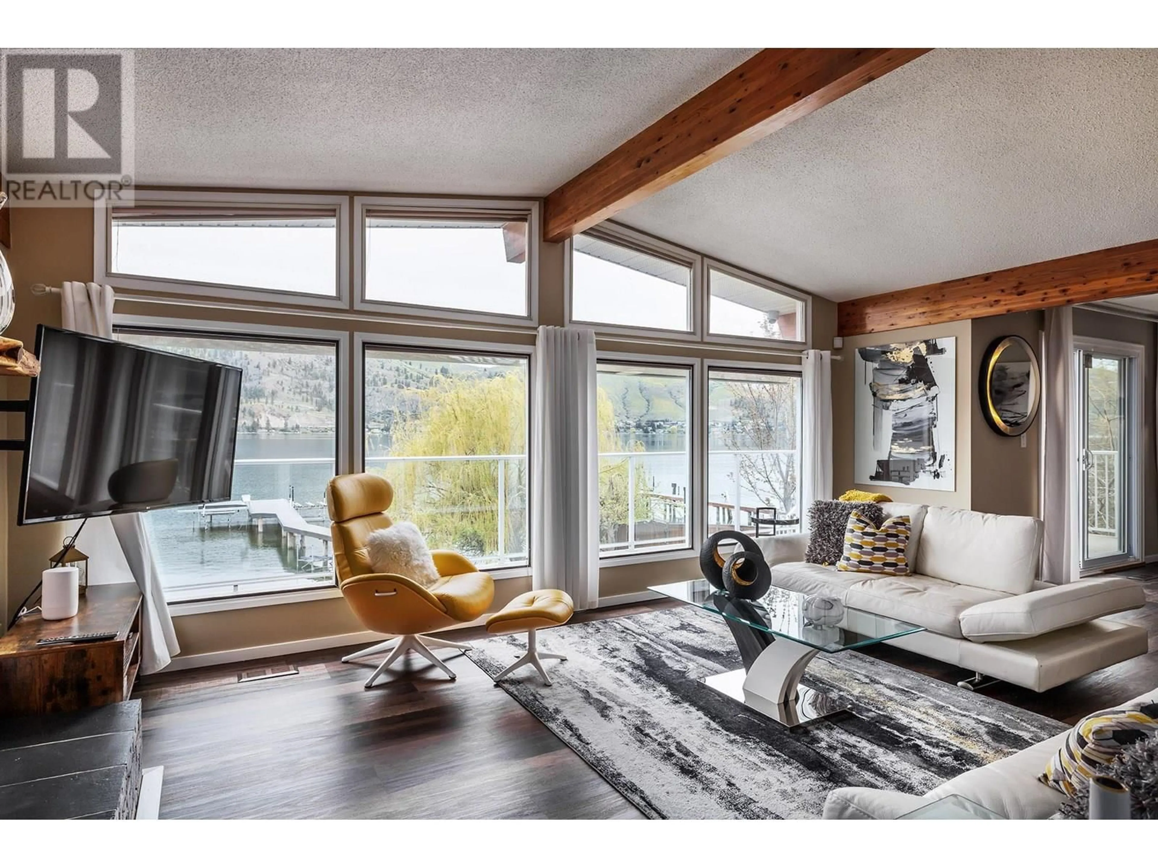 Living room with furniture, wood/laminate floor for 8291 OKANAGAN LANDING ROAD, Vernon British Columbia V1H1J5