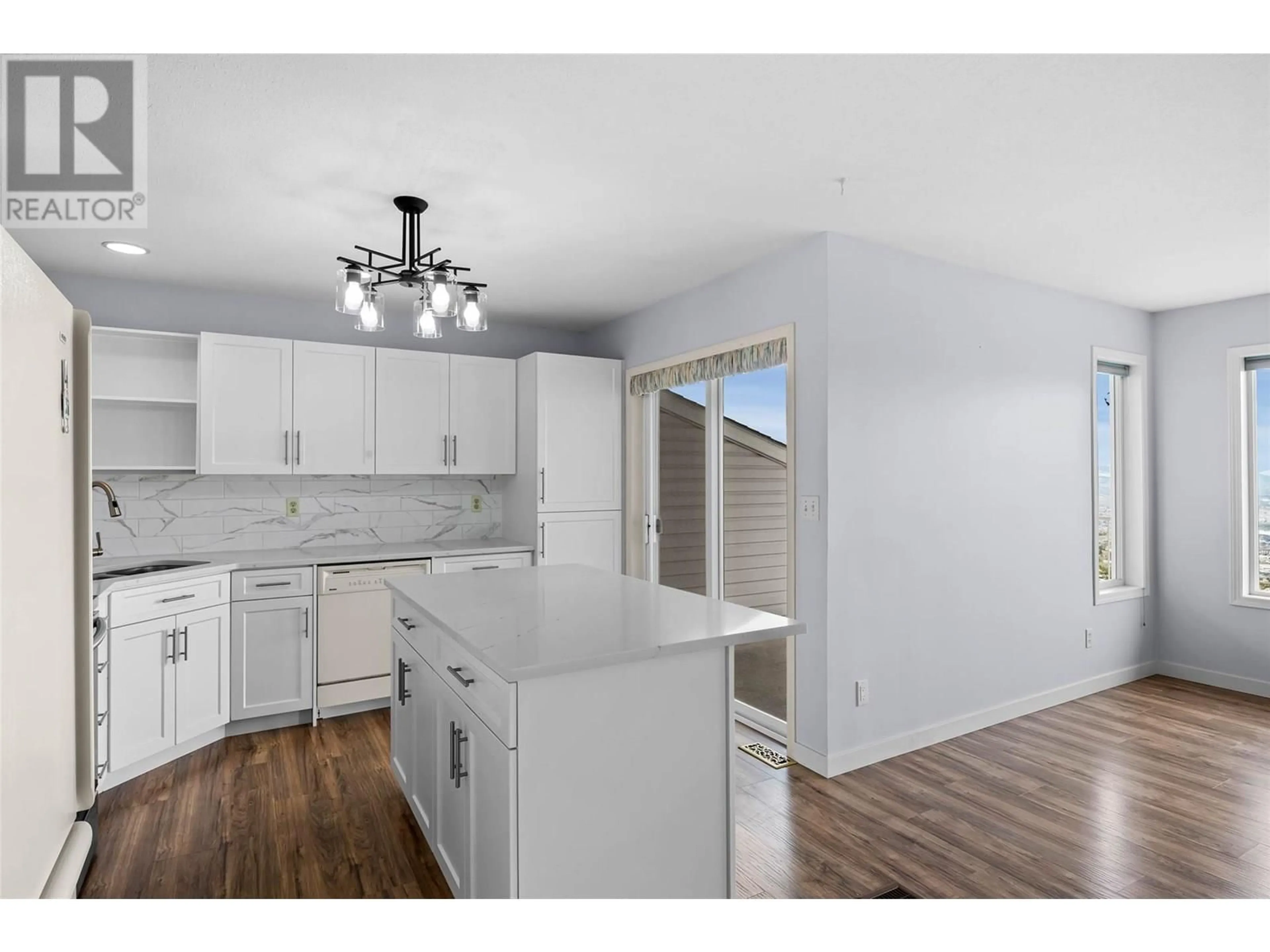 Open concept kitchen, wood/laminate floor for 69 - 2022 PACIFIC WAY, Kamloops British Columbia V1S1T1