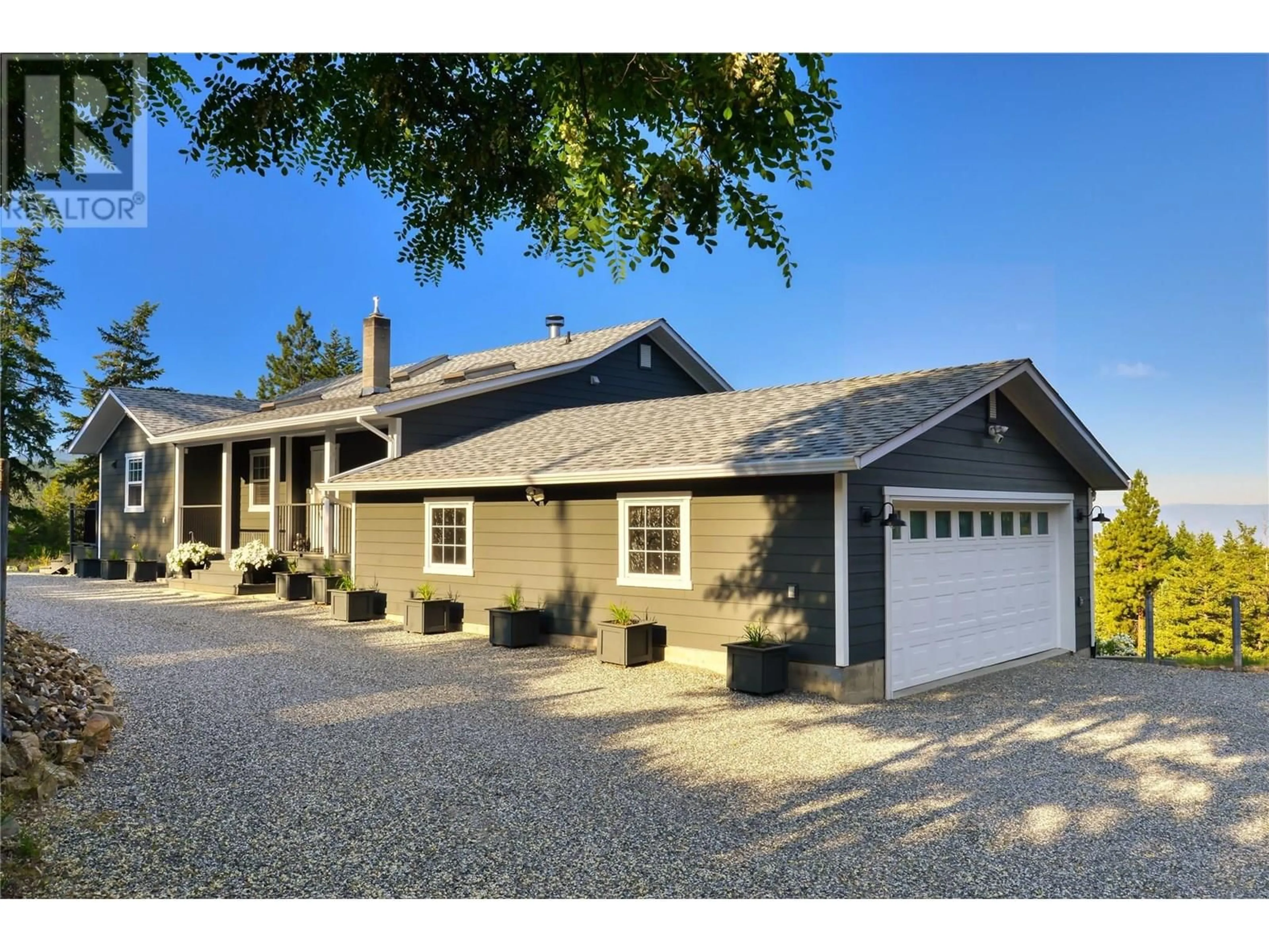 Home with vinyl exterior material, street for 2025 HUCKLEBERRY ROAD, Kelowna British Columbia V1P1H5