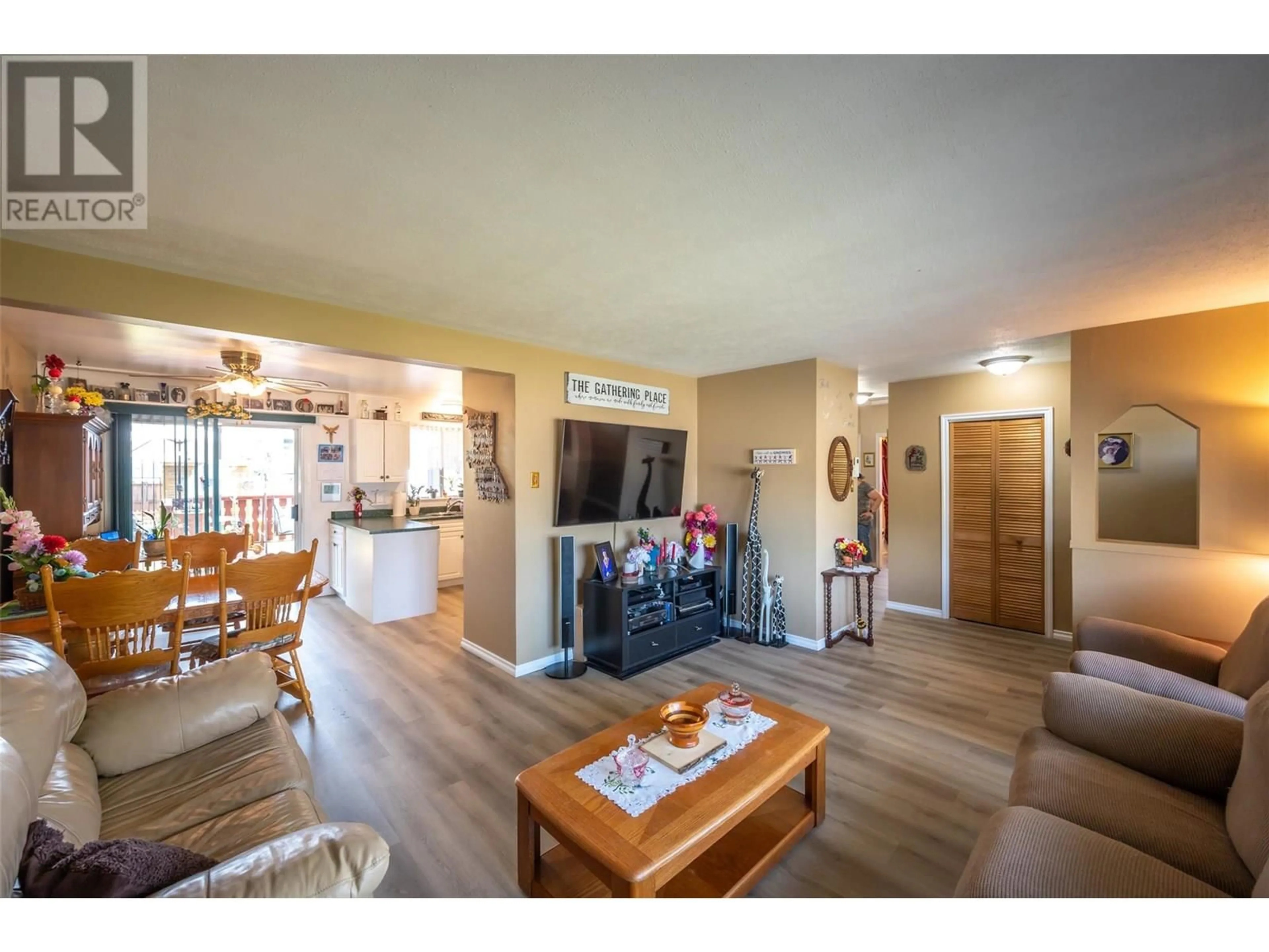 Living room with furniture, wood/laminate floor for 238 HUTH AVENUE, Penticton British Columbia V2A3A2