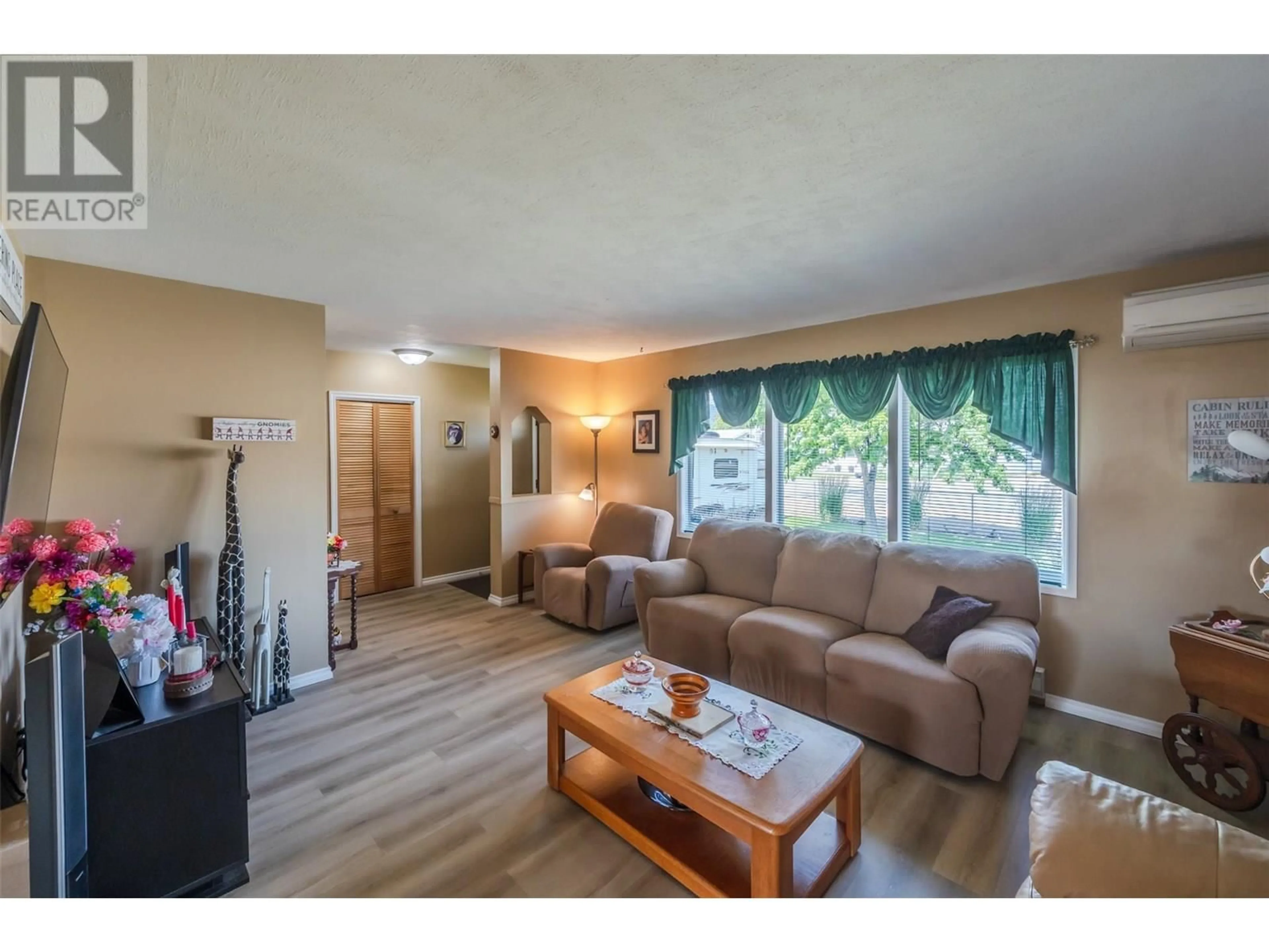 Living room with furniture, wood/laminate floor for 238 HUTH AVENUE, Penticton British Columbia V2A3A2