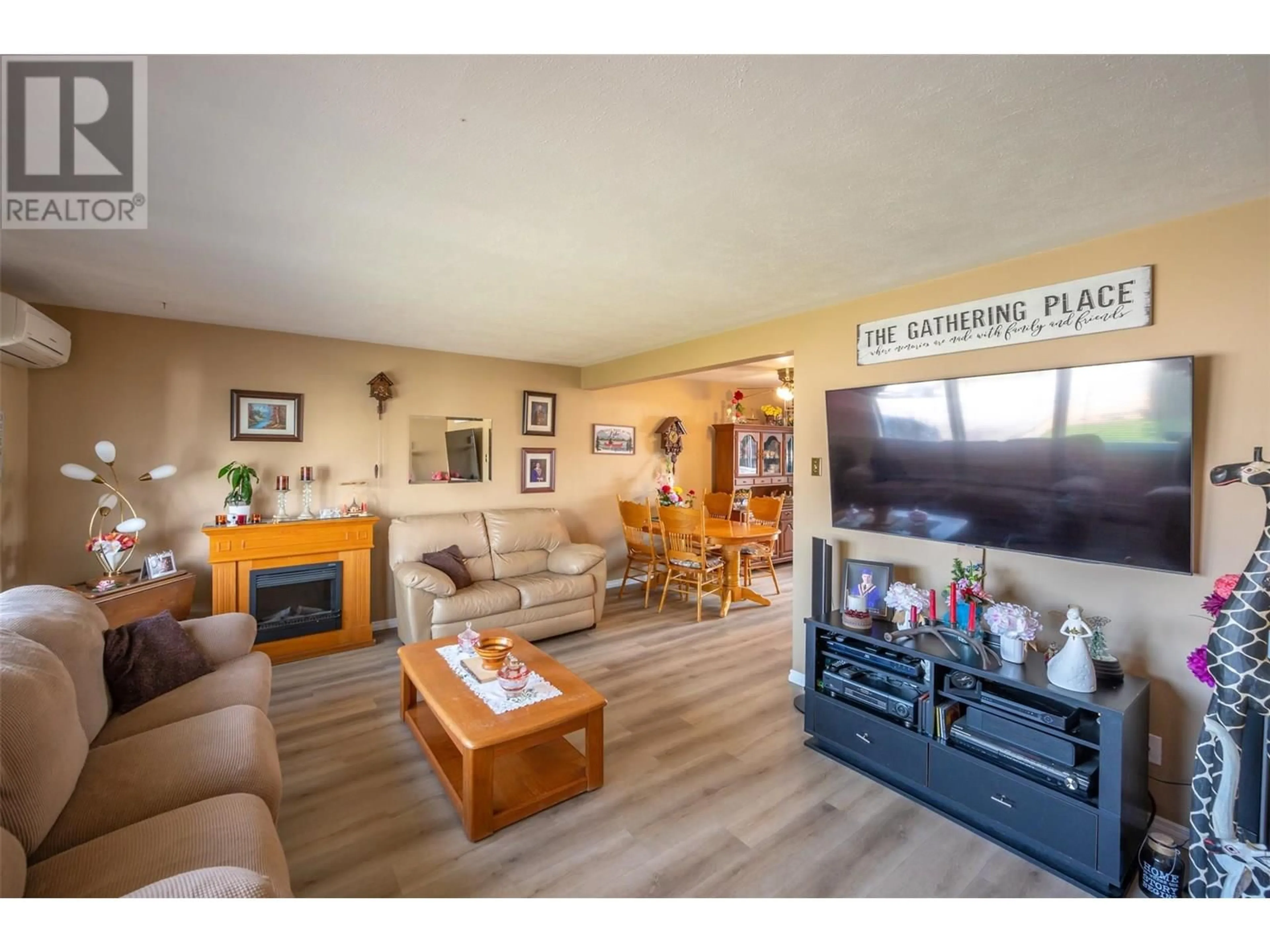 Living room with furniture, wood/laminate floor for 238 HUTH AVENUE, Penticton British Columbia V2A3A2