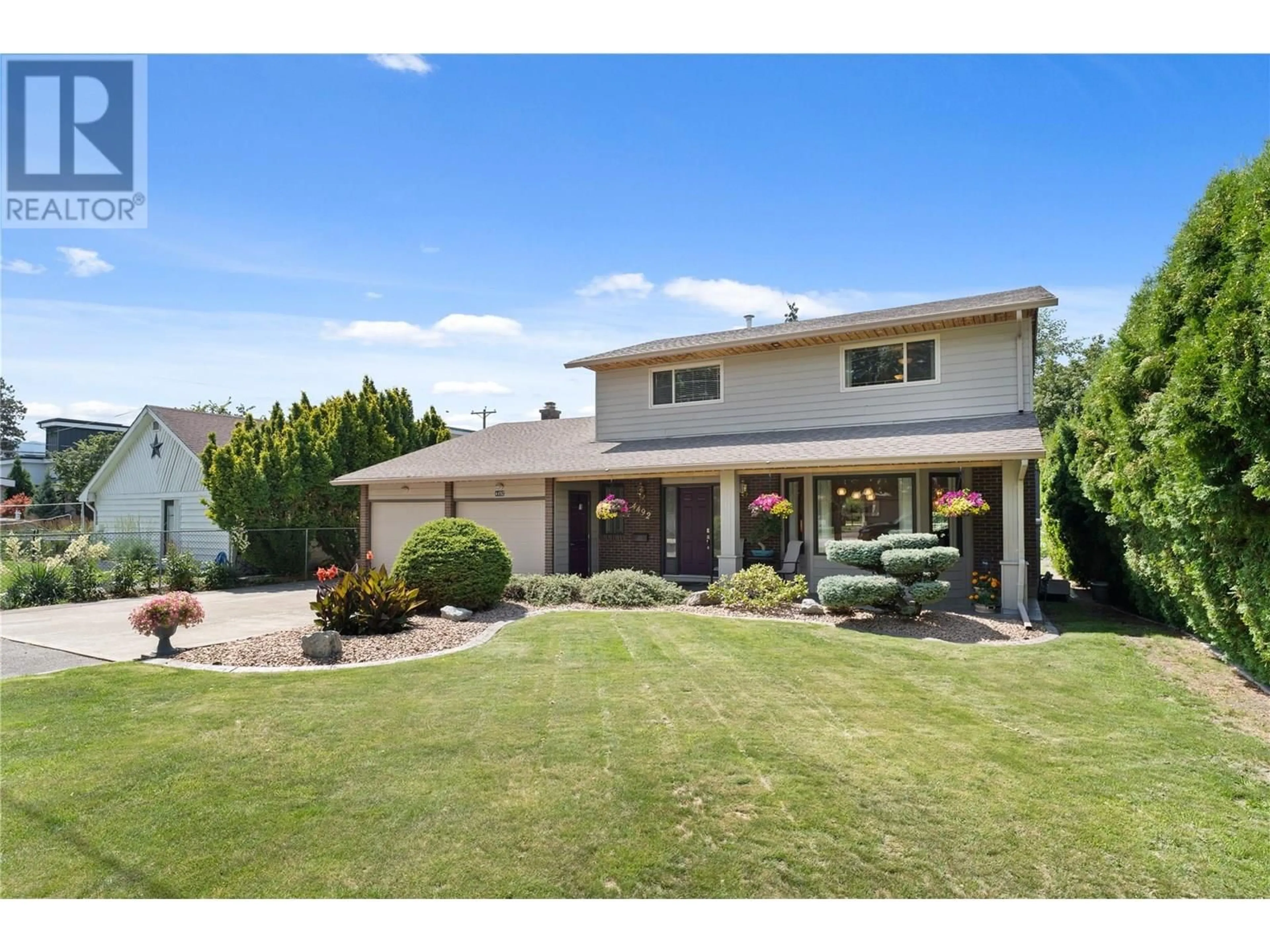 A pic from outside/outdoor area/front of a property/back of a property/a pic from drone, street for 4492 SWAISLAND ROAD, Kelowna British Columbia V1W1Y7