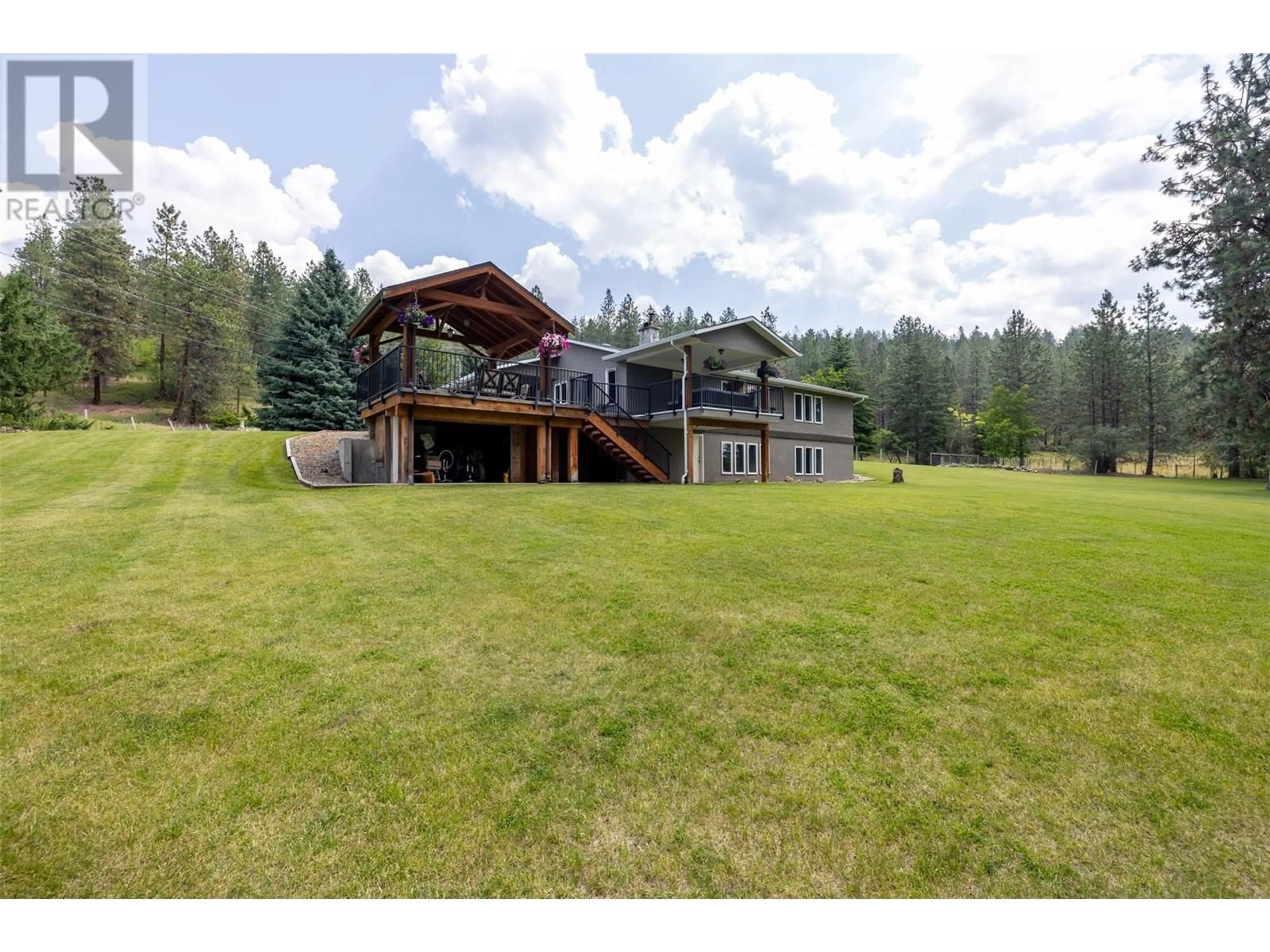 A pic from outside/outdoor area/front of a property/back of a property/a pic from drone, mountain view for 6051 POSTILL LAKE ROAD, Kelowna British Columbia V1X7V3
