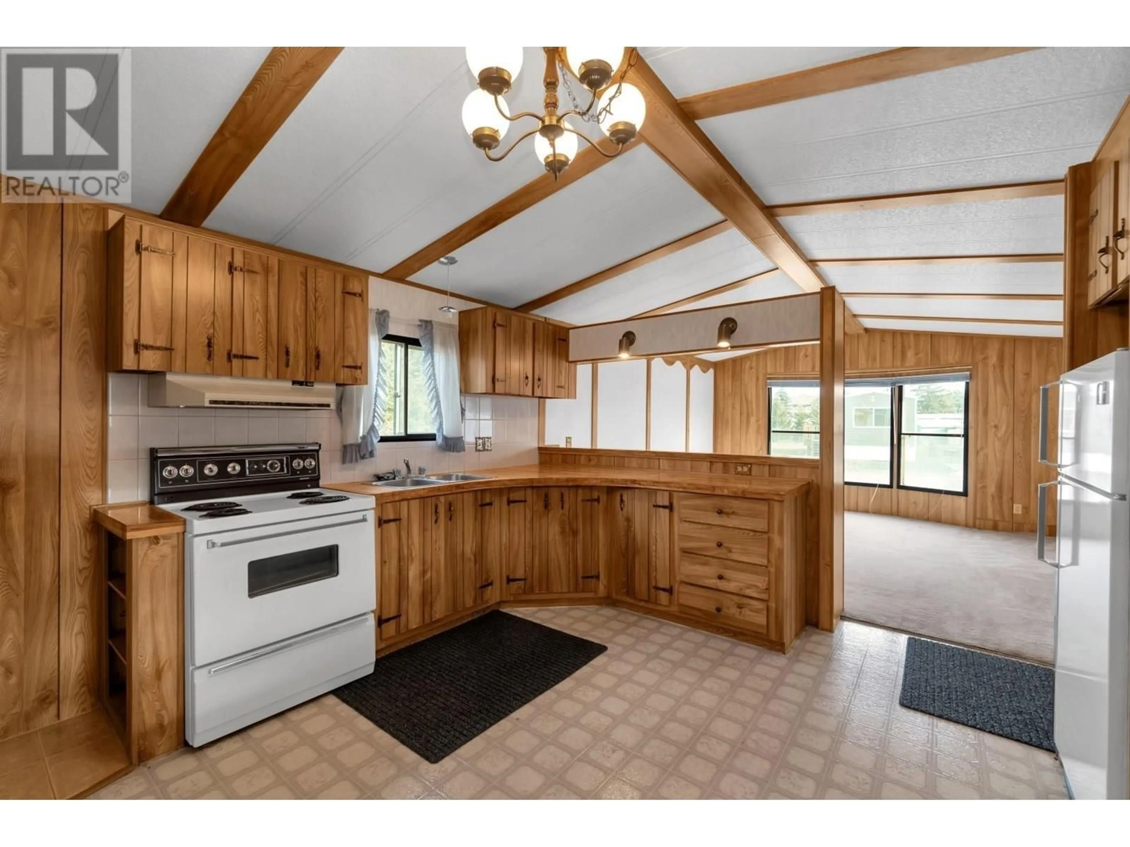 Open concept kitchen, wood/laminate floor for 105 - 2776 CLAPPERTON AVENUE, Merritt British Columbia V0K1B0