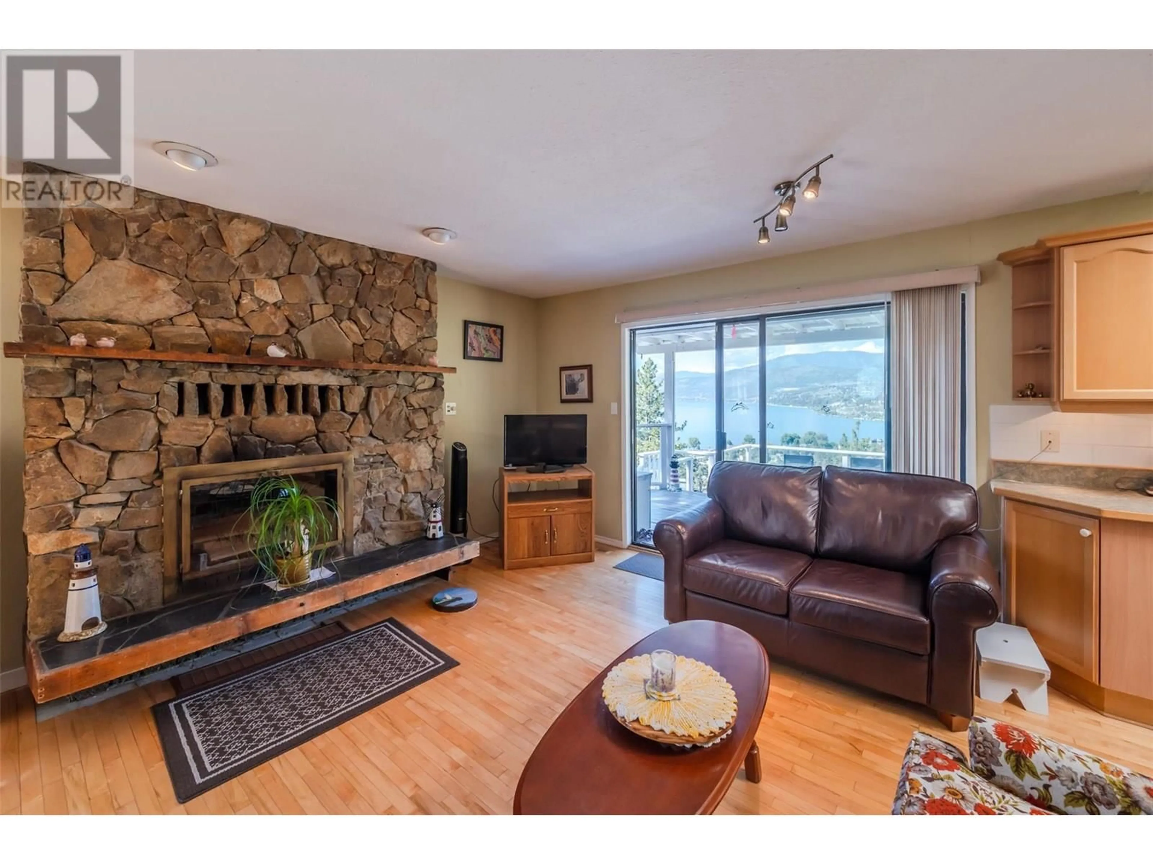Living room with furniture, wood/laminate floor for 3906 DESERT PINES AVENUE, Peachland British Columbia V0H1X2