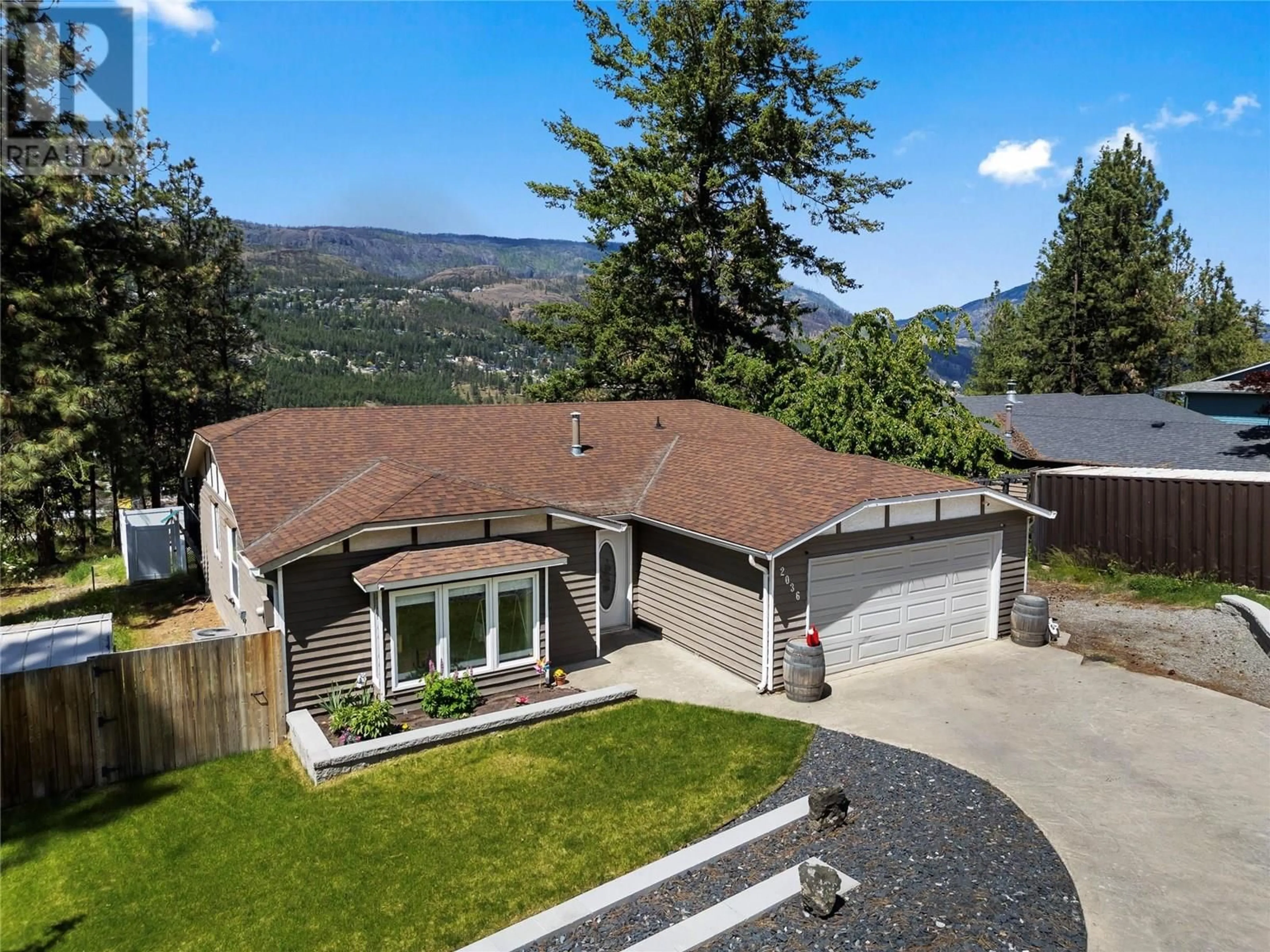 A pic from outside/outdoor area/front of a property/back of a property/a pic from drone, mountain view for 2036 TOMAT AVENUE, West Kelowna British Columbia V1Z3C5