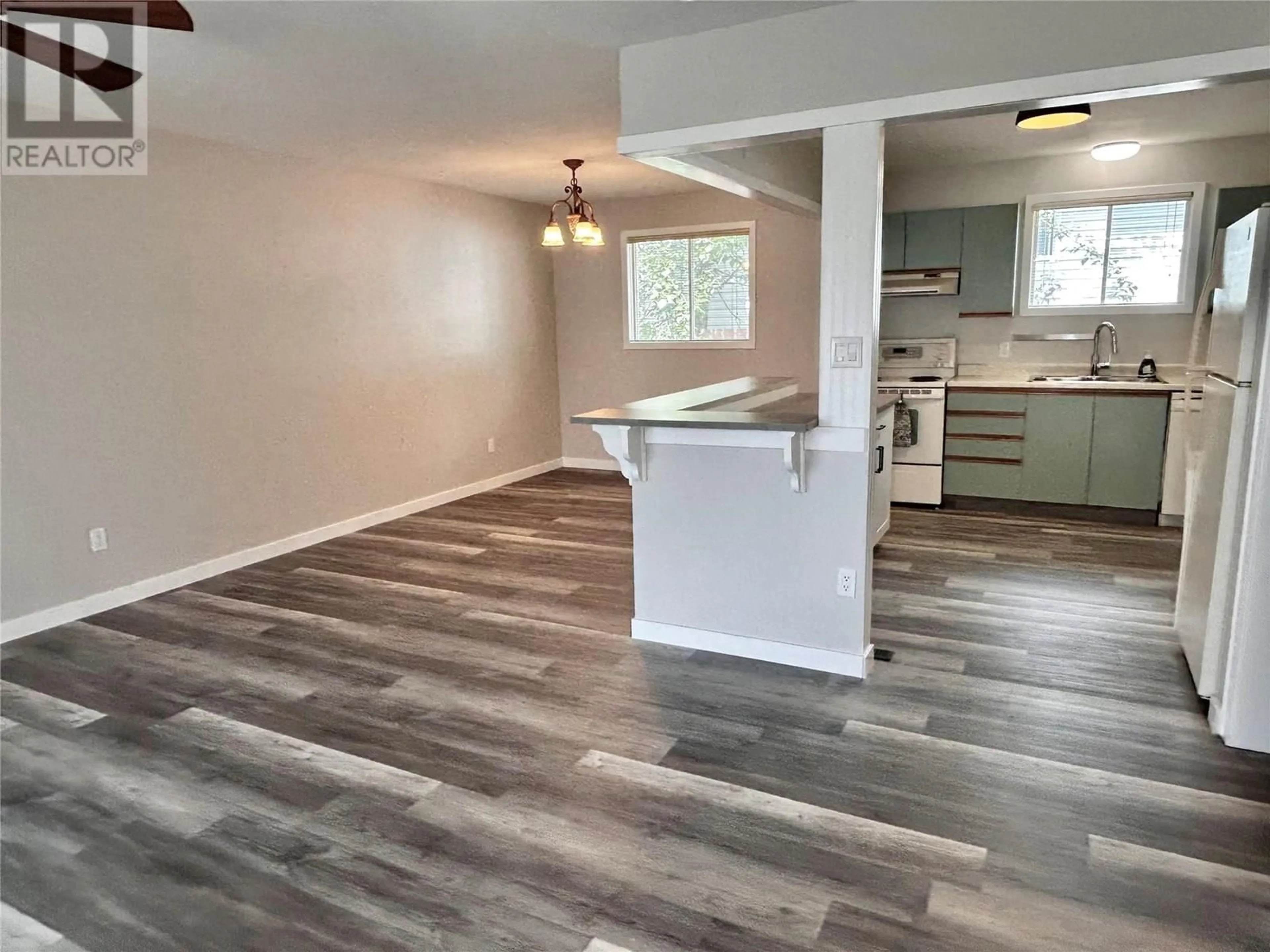 Open concept kitchen, wood/laminate floor for 104 GWILLIM CRESCENT, Tumbler Ridge British Columbia V0C2W0