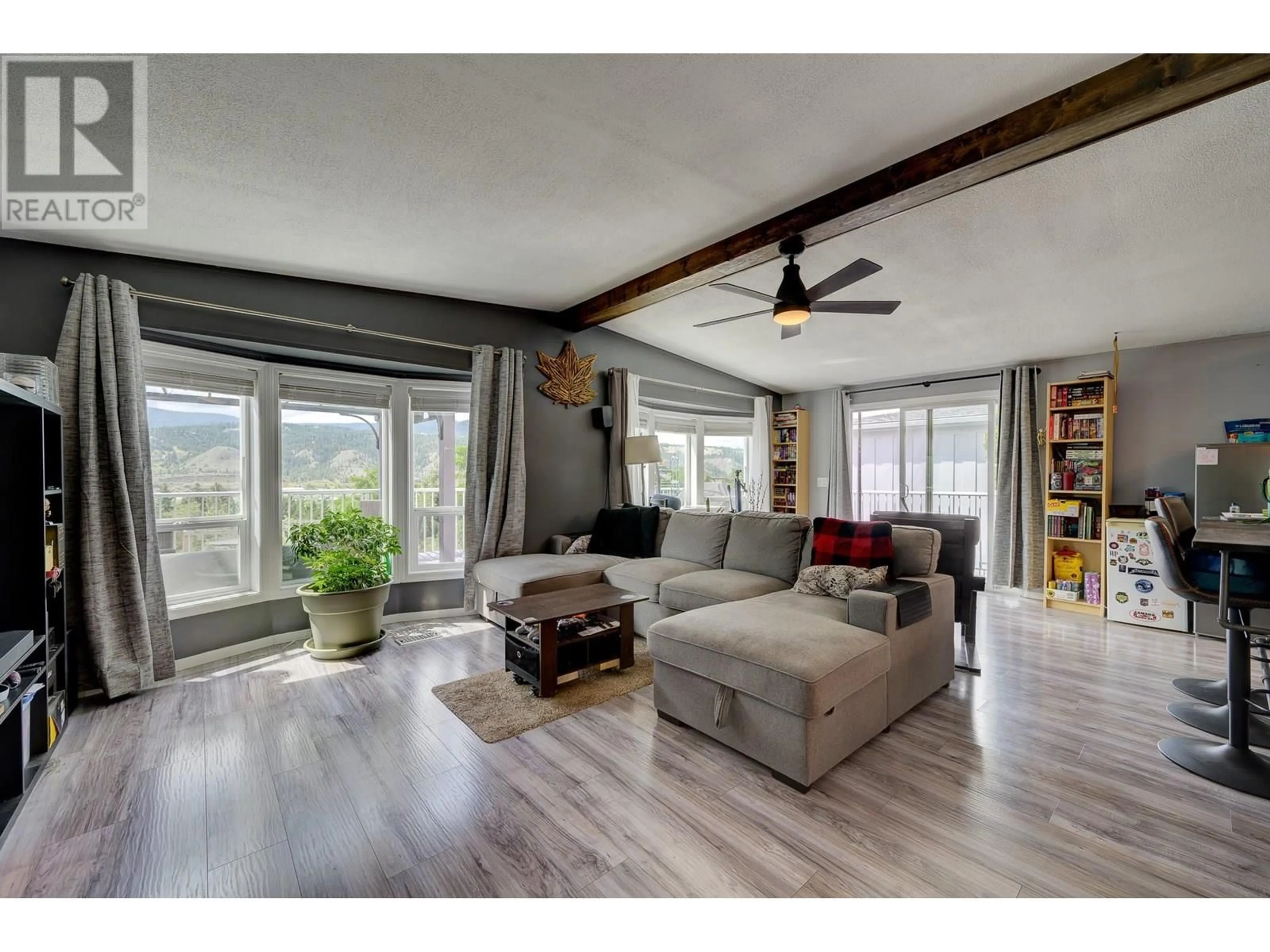 Living room with furniture, wood/laminate floor for 19 - 3099 SHUSWAP ROAD EAST, Kamloops British Columbia V2H1T7