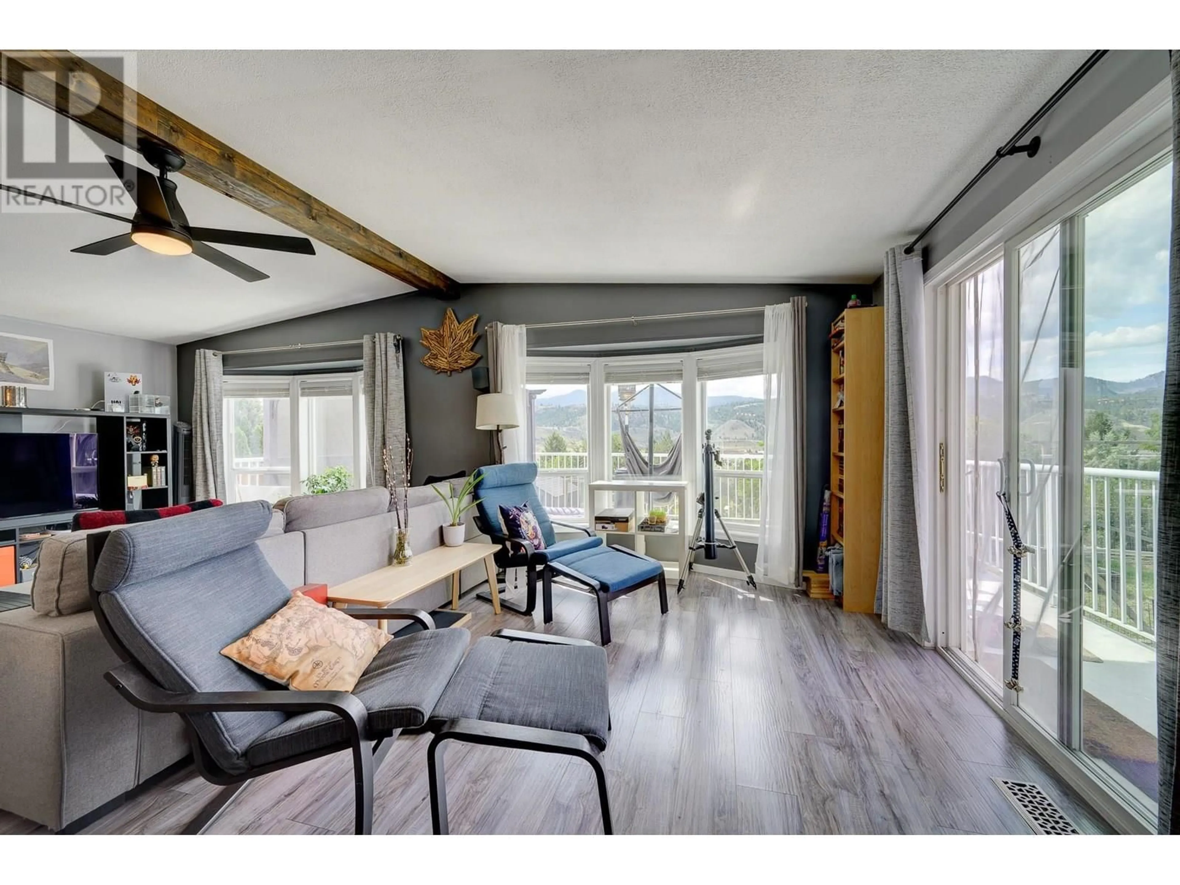 Living room with furniture, wood/laminate floor for 19 - 3099 SHUSWAP ROAD EAST, Kamloops British Columbia V2H1T7