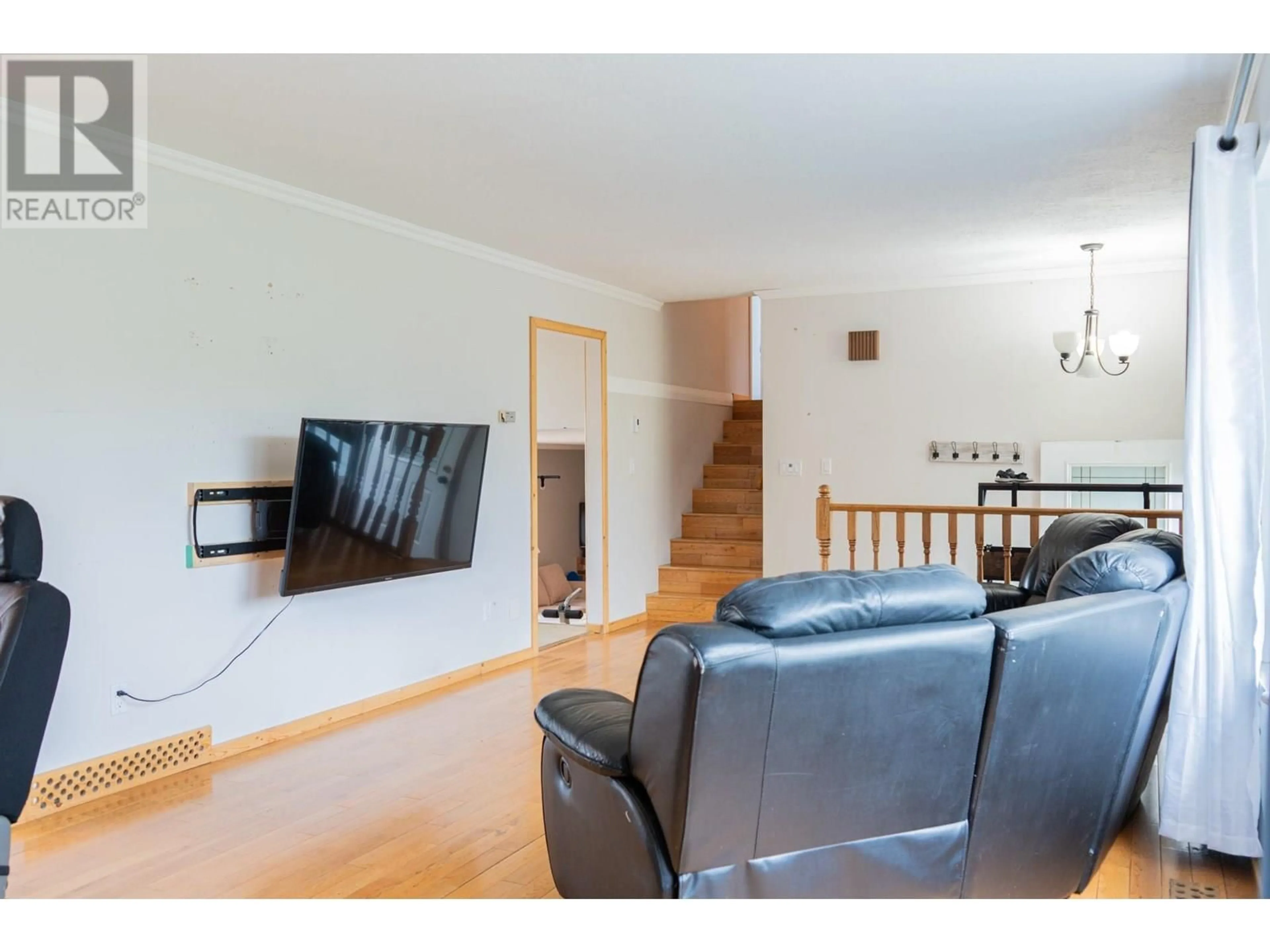 Living room with furniture, wood/laminate floor for 1537 109 AVENUE, Dawson Creek British Columbia V1G2V3