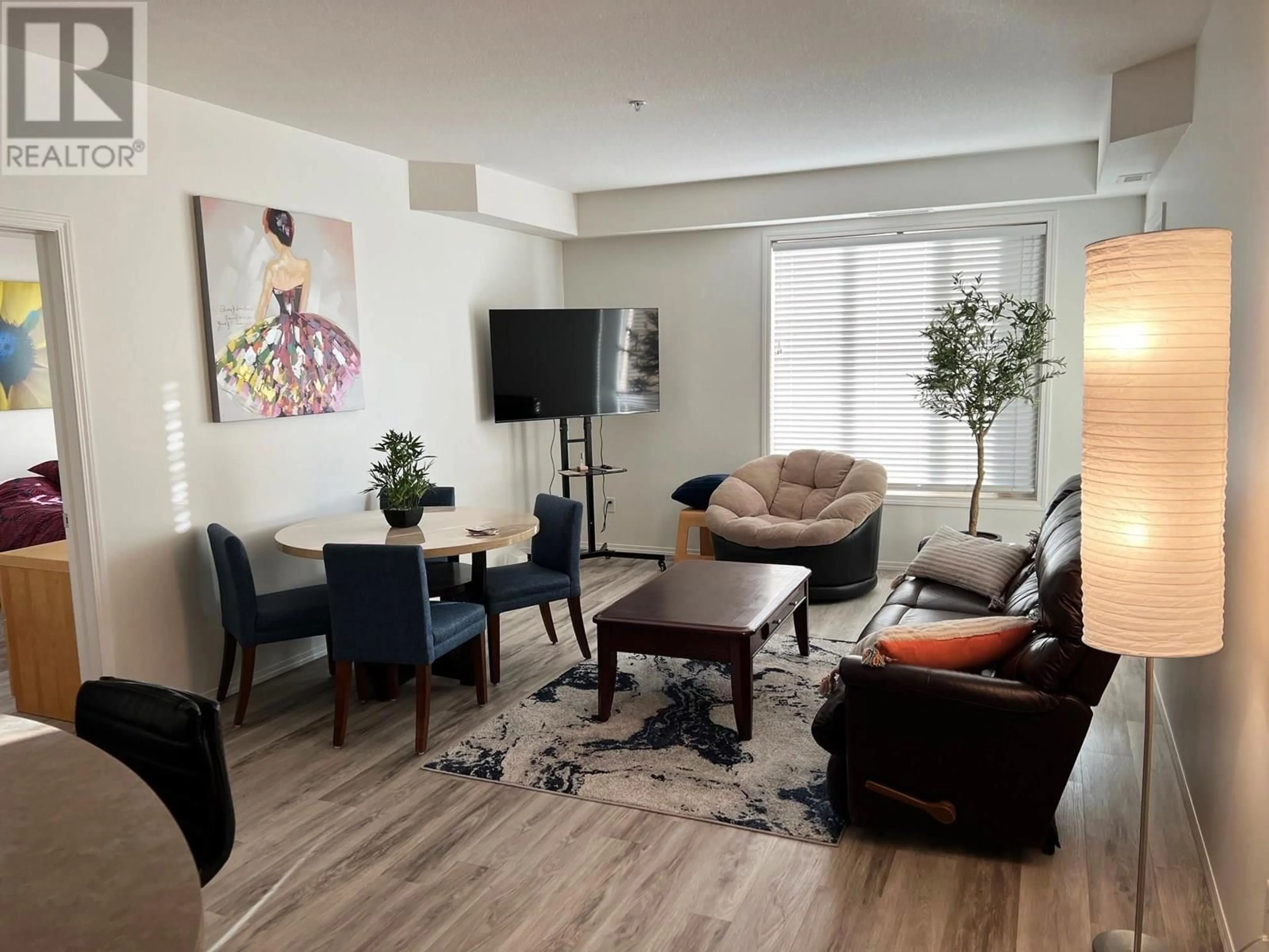 Living room with furniture, wood/laminate floor for 2415 - 1873 COUNTRY CLUB DRIVE, Kelowna British Columbia V1V2W7