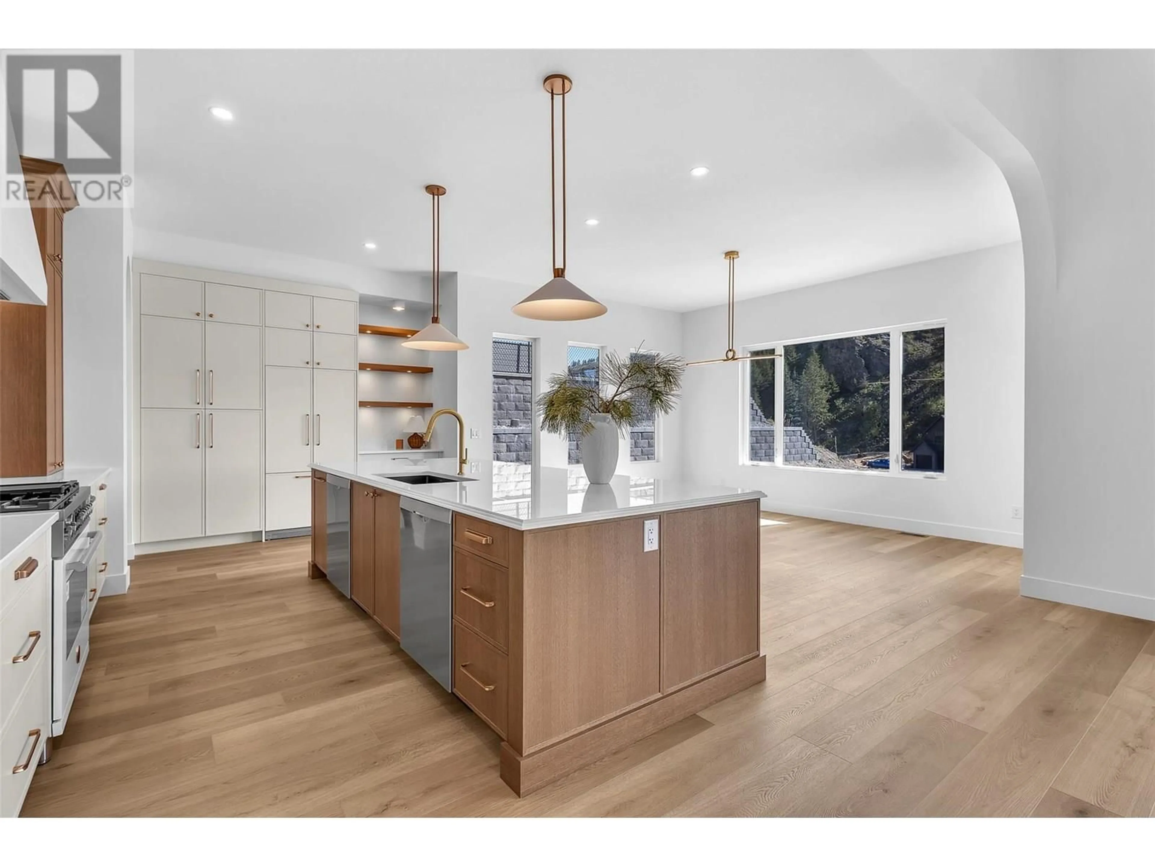 Open concept kitchen, wood/laminate floor for 1439 WHISTLING PINE PLACE, Kelowna British Columbia V1V2C6