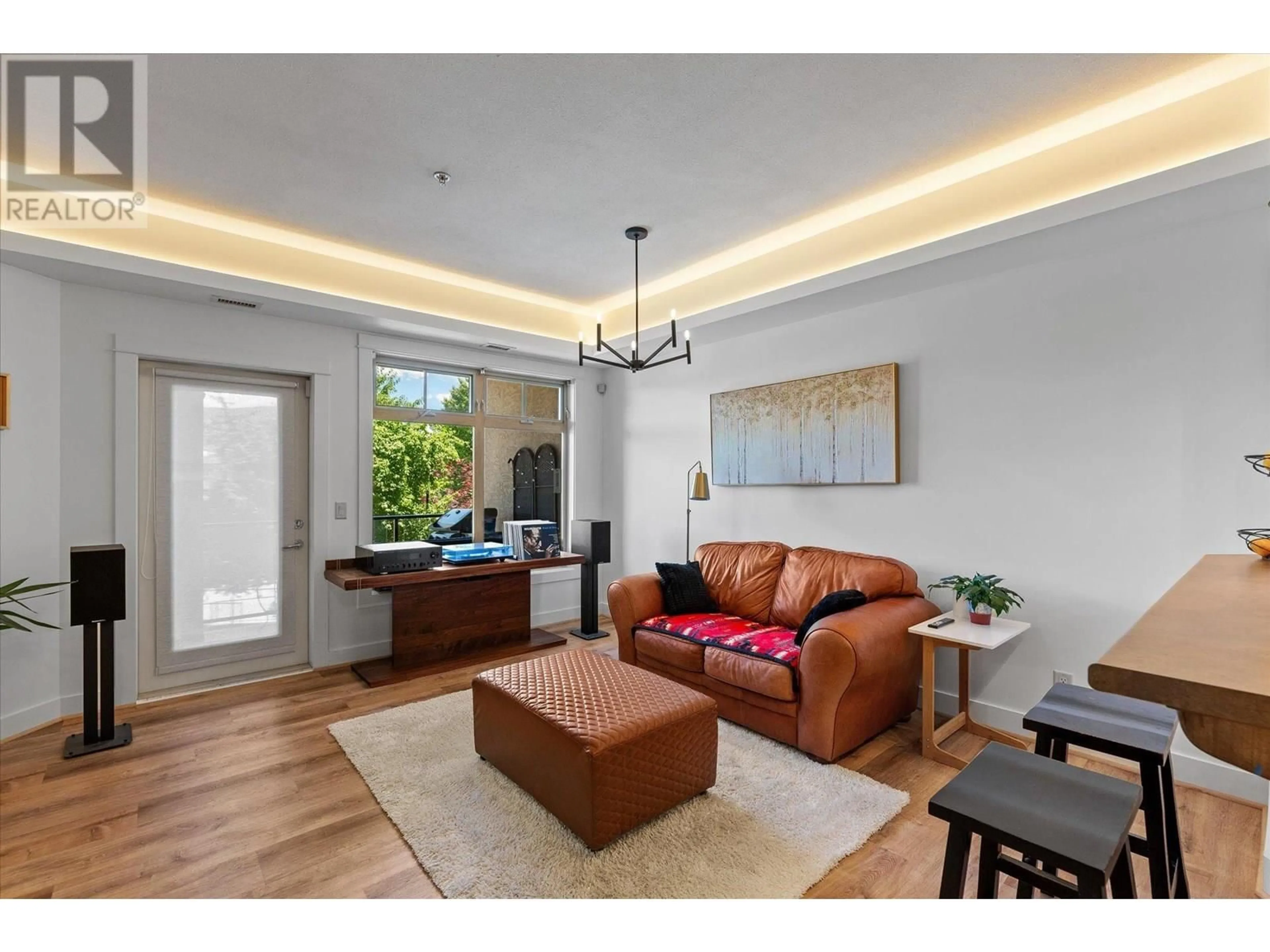 Living room with furniture, wood/laminate floor for 204 - 2551 SHORELINE DRIVE, Lake Country British Columbia V4P2P2