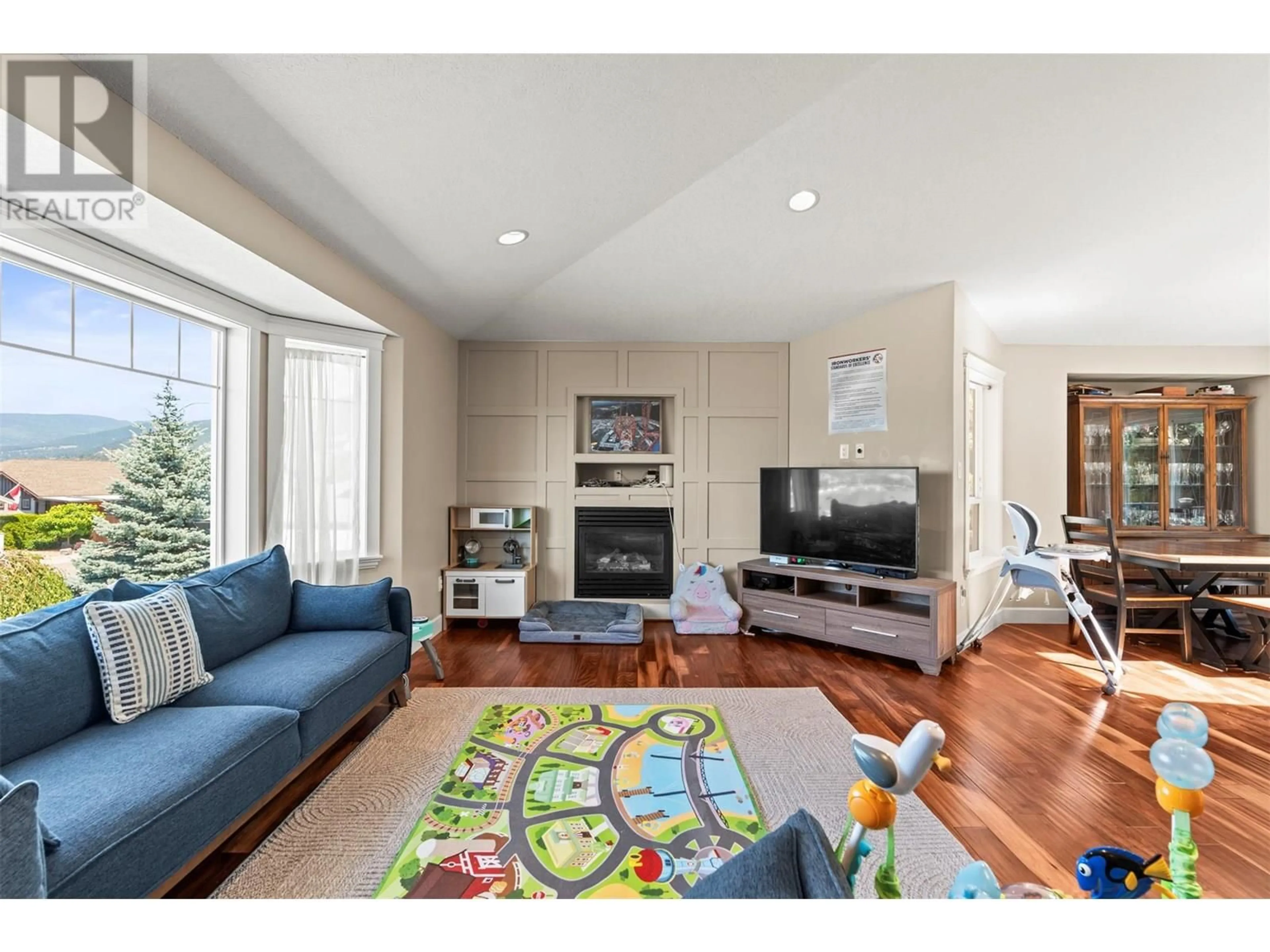 Living room with furniture, wood/laminate floor for 901 MT GRADY ROAD, Vernon British Columbia V1B4B6