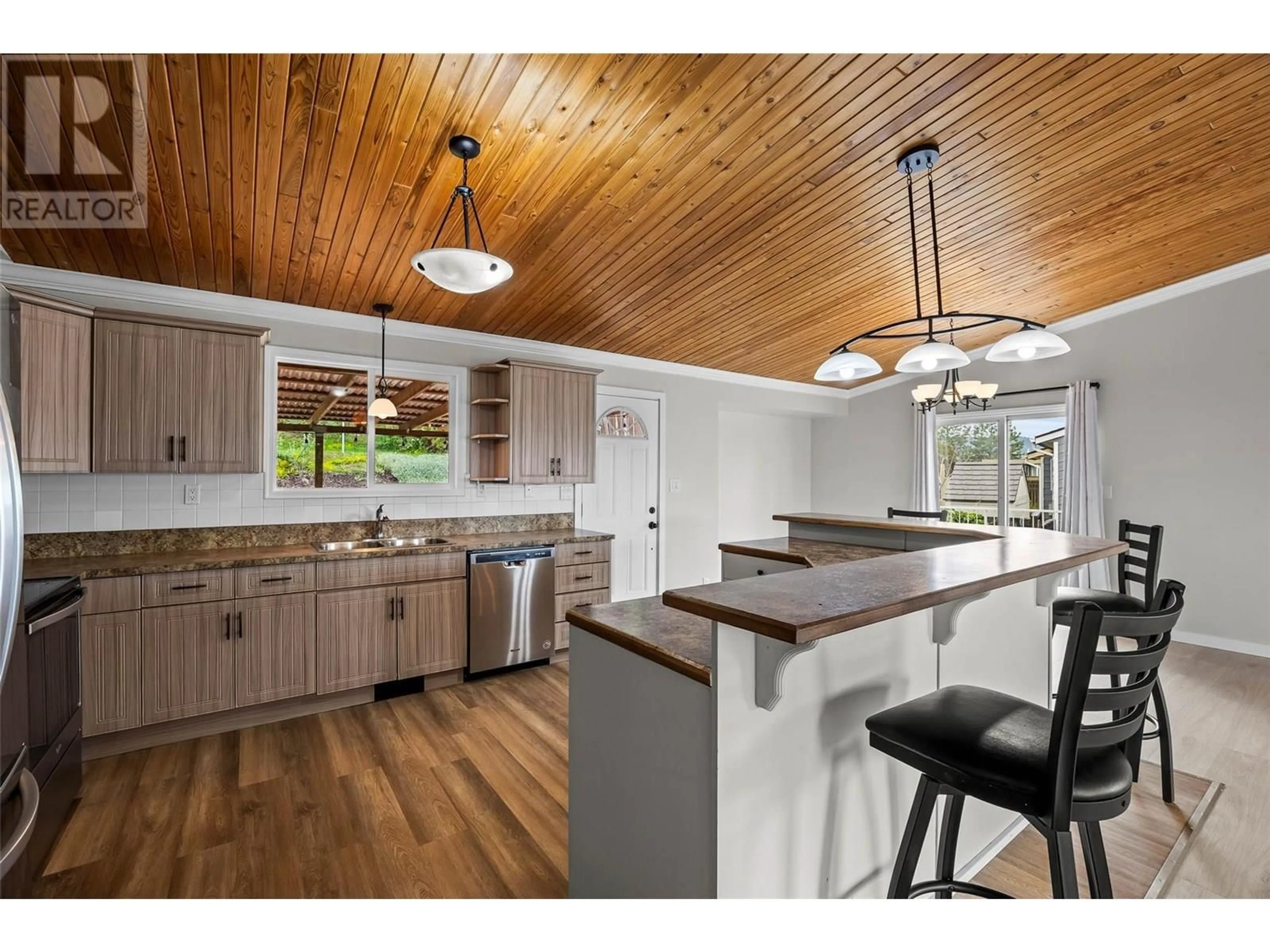 Open concept kitchen, wood/laminate floor for 403 GLENEAGLES DRIVE, Kamloops British Columbia V2E1Y4
