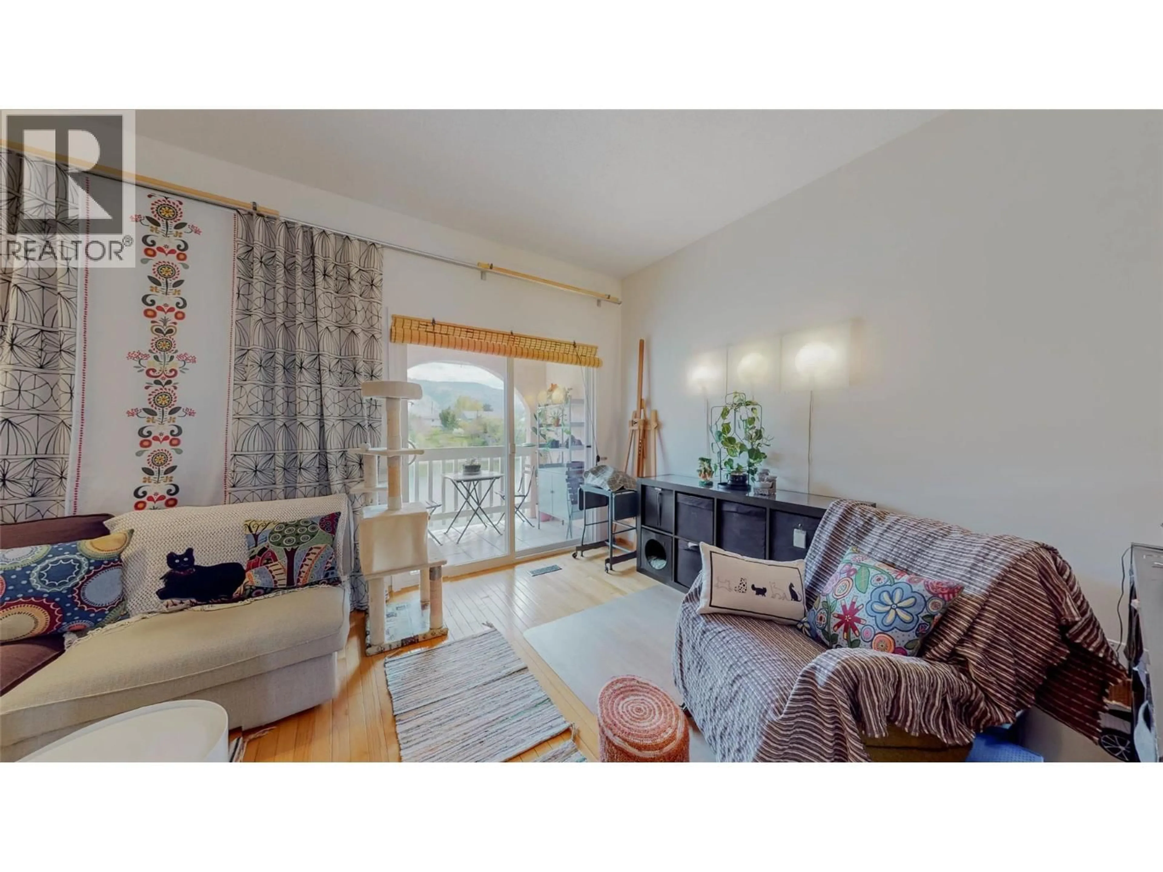 Living room with furniture, wood/laminate floor for 8029 VEDETTE DRIVE, Osoyoos British Columbia V0H1V2