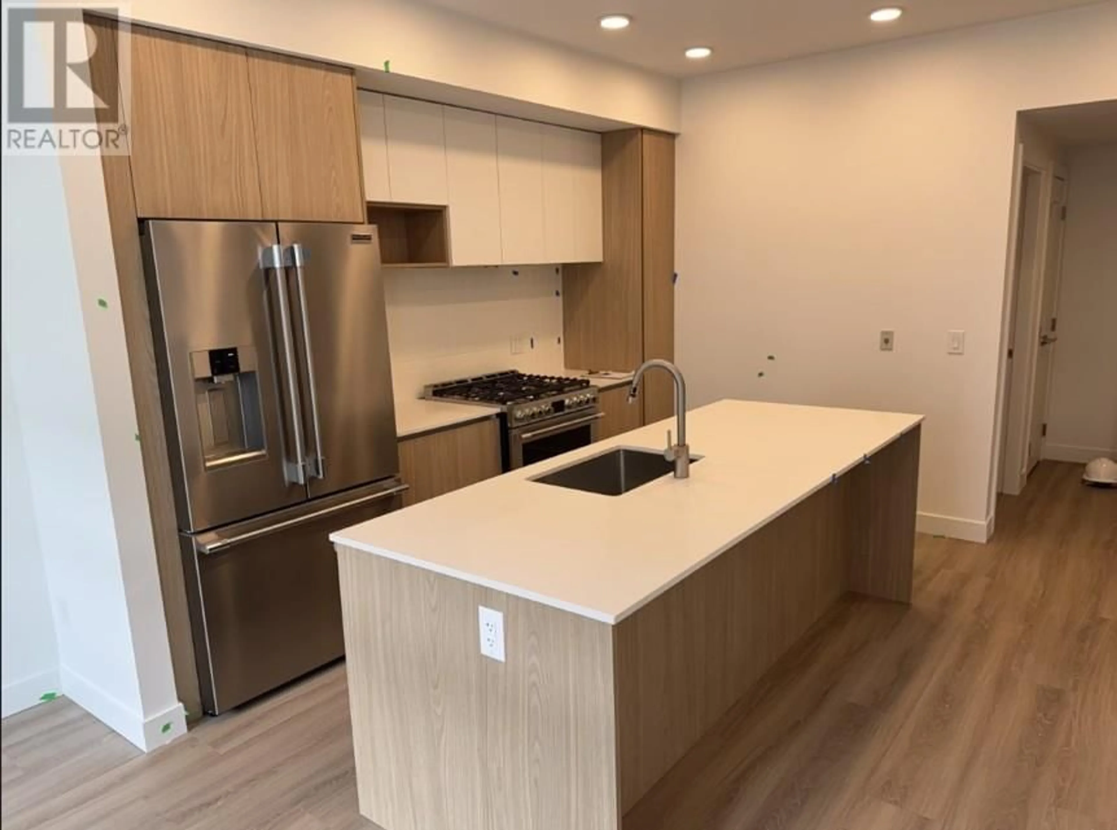 Open concept kitchen, wood/laminate floor for 303 - 2750 OLALLA ROAD, West Kelowna British Columbia V1Z2A9
