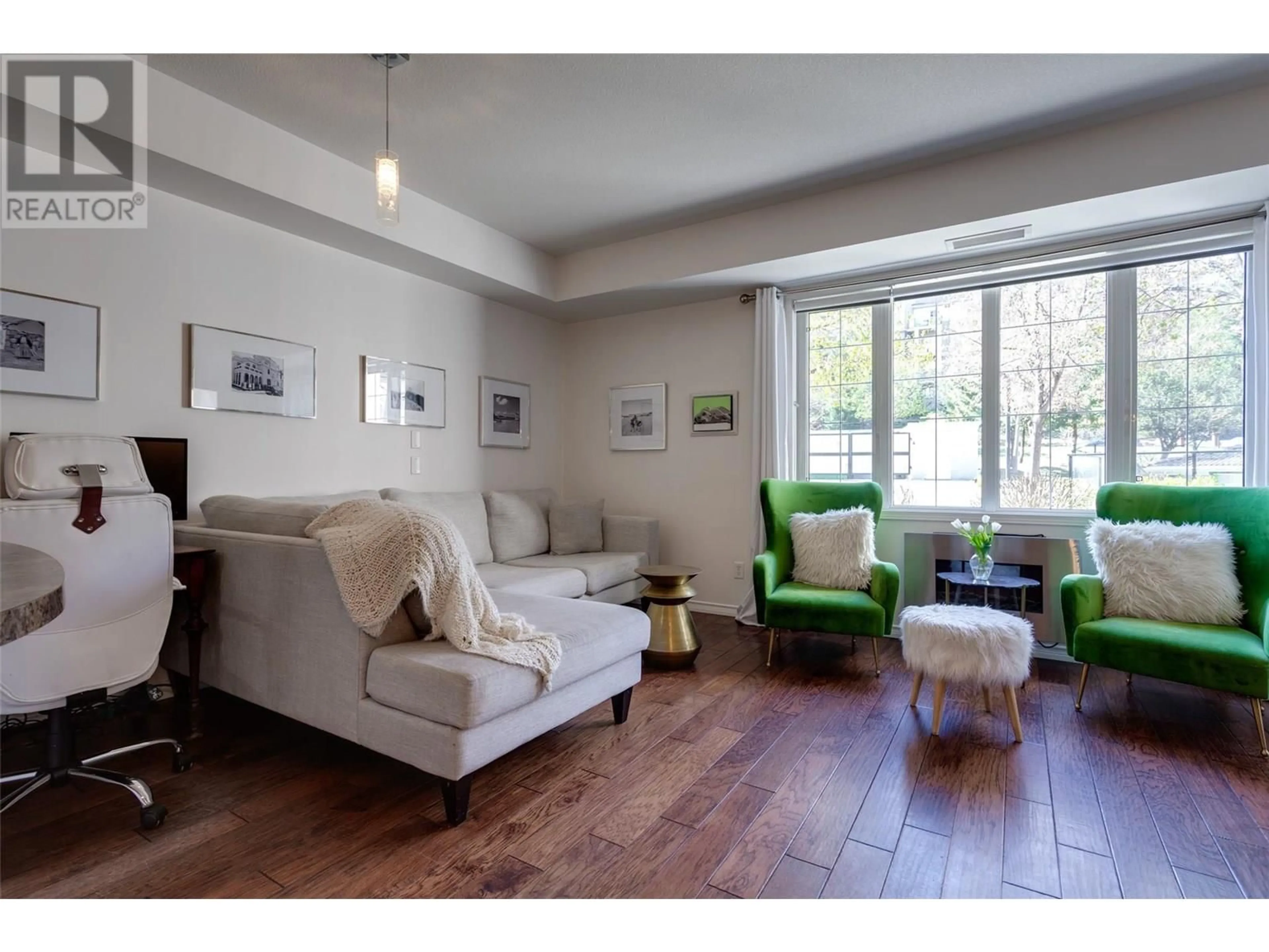 Living room with furniture, wood/laminate floor for 2102 - 3178 VIA CENTRALE DRIVE, Kelowna British Columbia V1V2T3