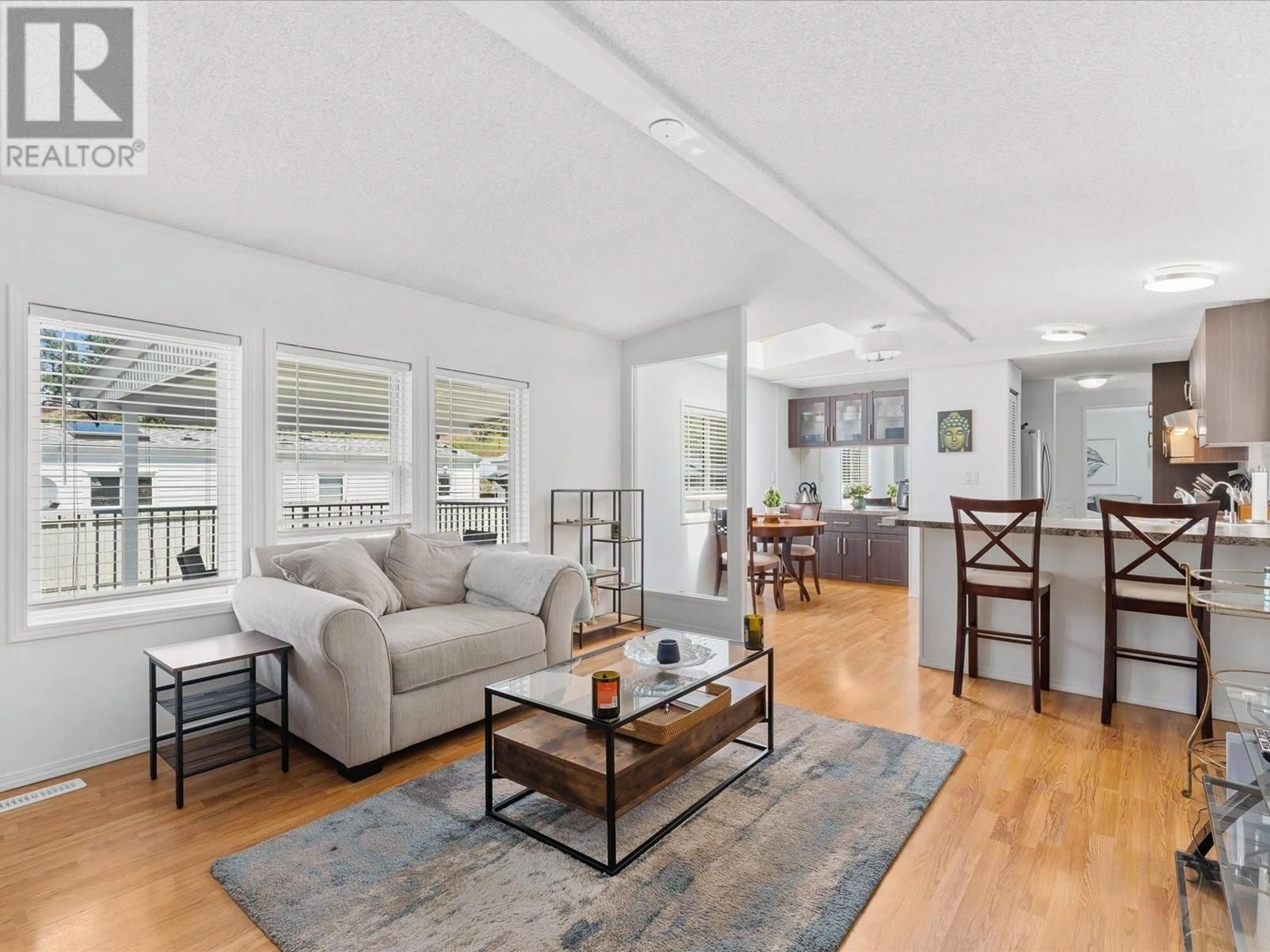 Living room with furniture, wood/laminate floor for 9 - 610 KATHERINE ROAD, West Kelowna British Columbia V1Z3G2