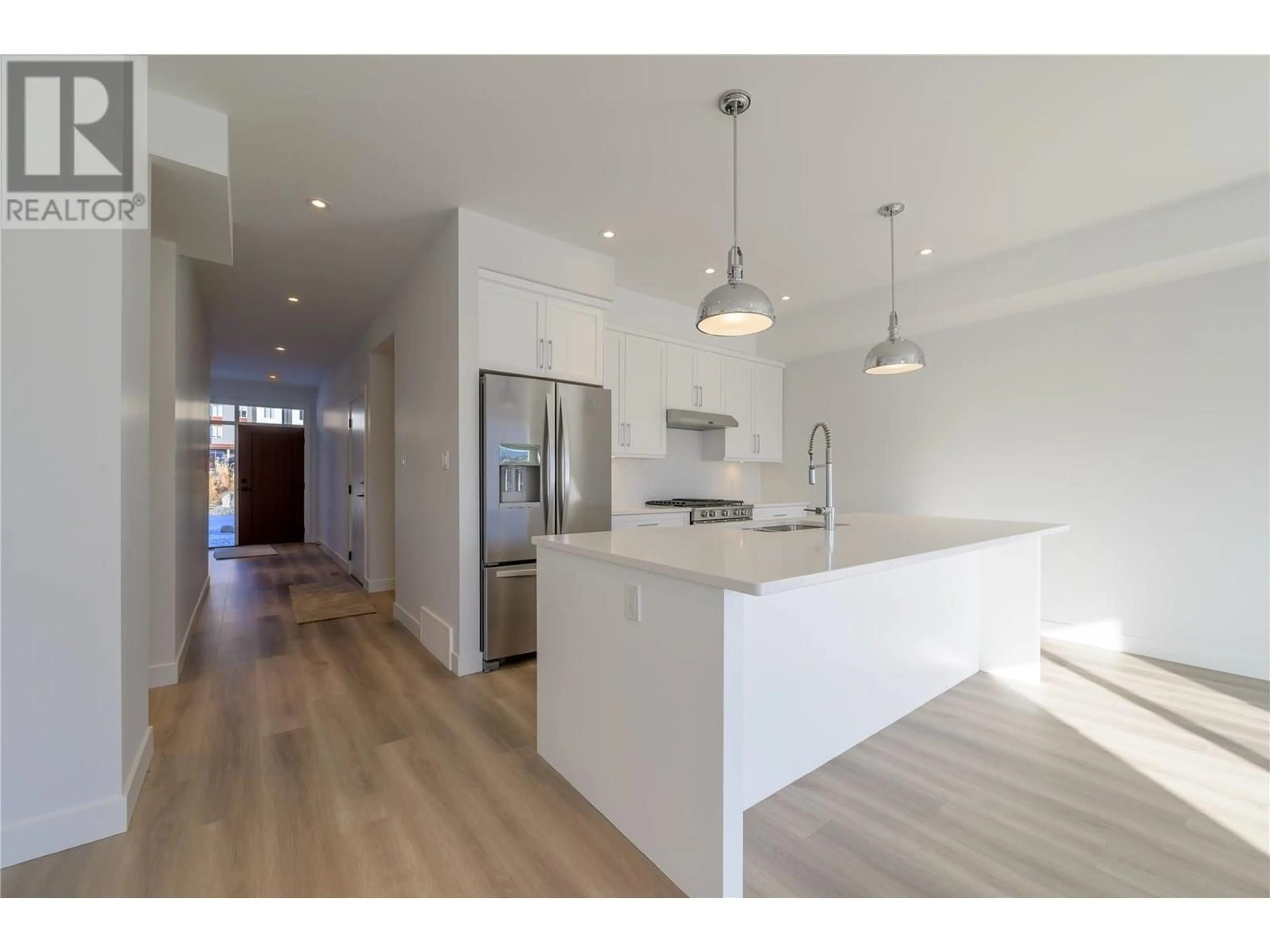 Open concept kitchen, wood/laminate floor for 127 RIVER GATE DRIVE, Kamloops British Columbia V2H0E4