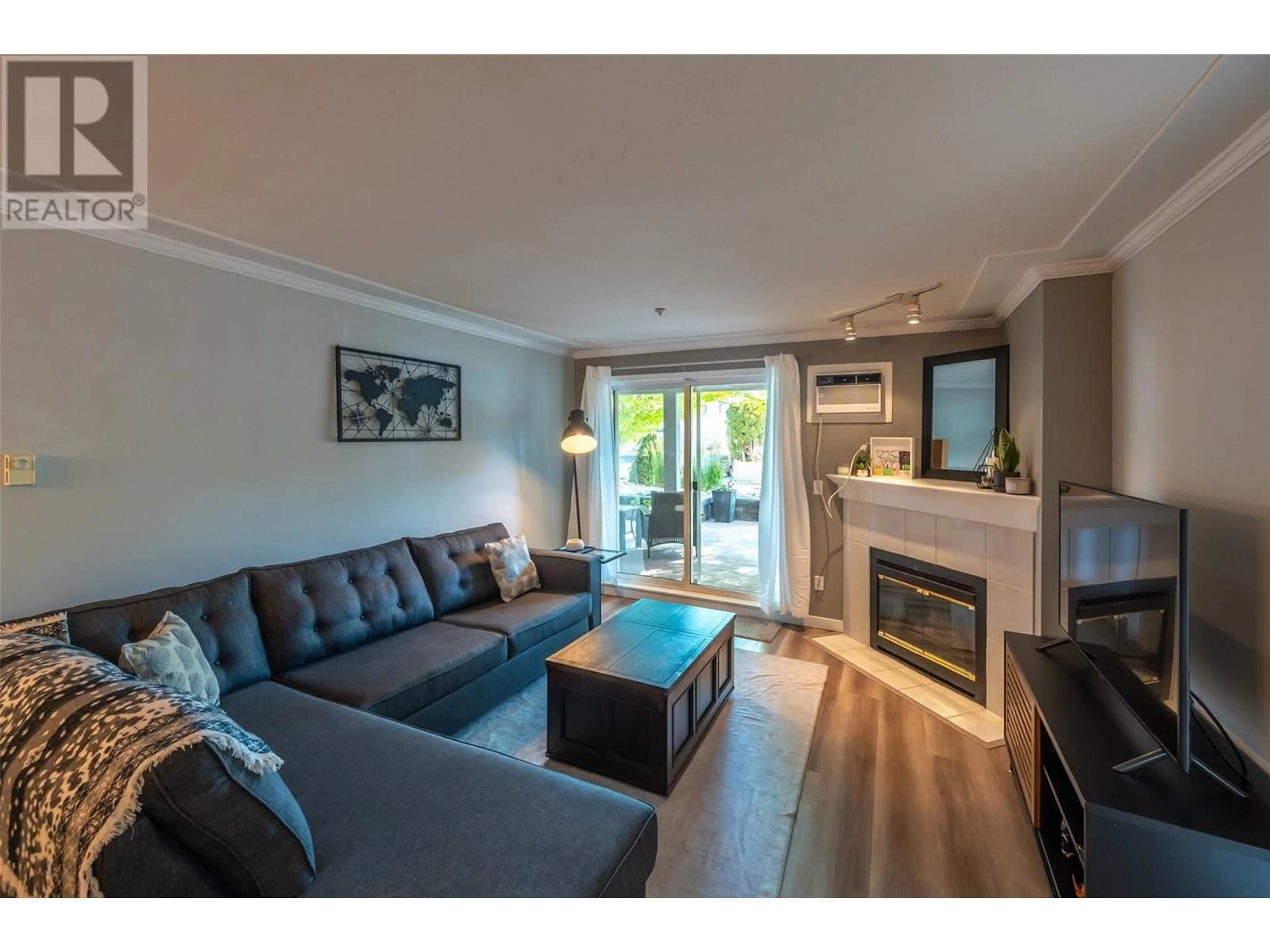 Living room with furniture, wood/laminate floor for 109 - 329 RIGSBY STREET, Penticton British Columbia V2A5S6