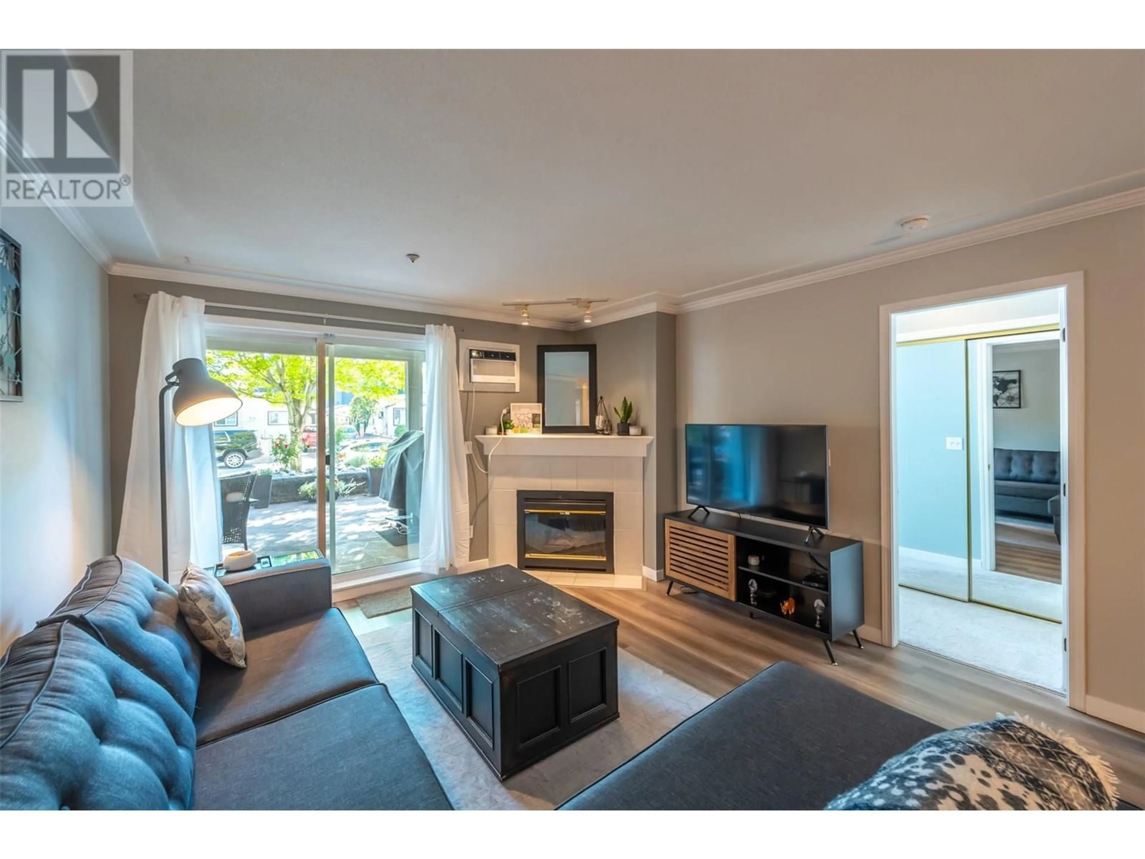 Living room with furniture, wood/laminate floor for 109 - 329 RIGSBY STREET, Penticton British Columbia V2A5S6