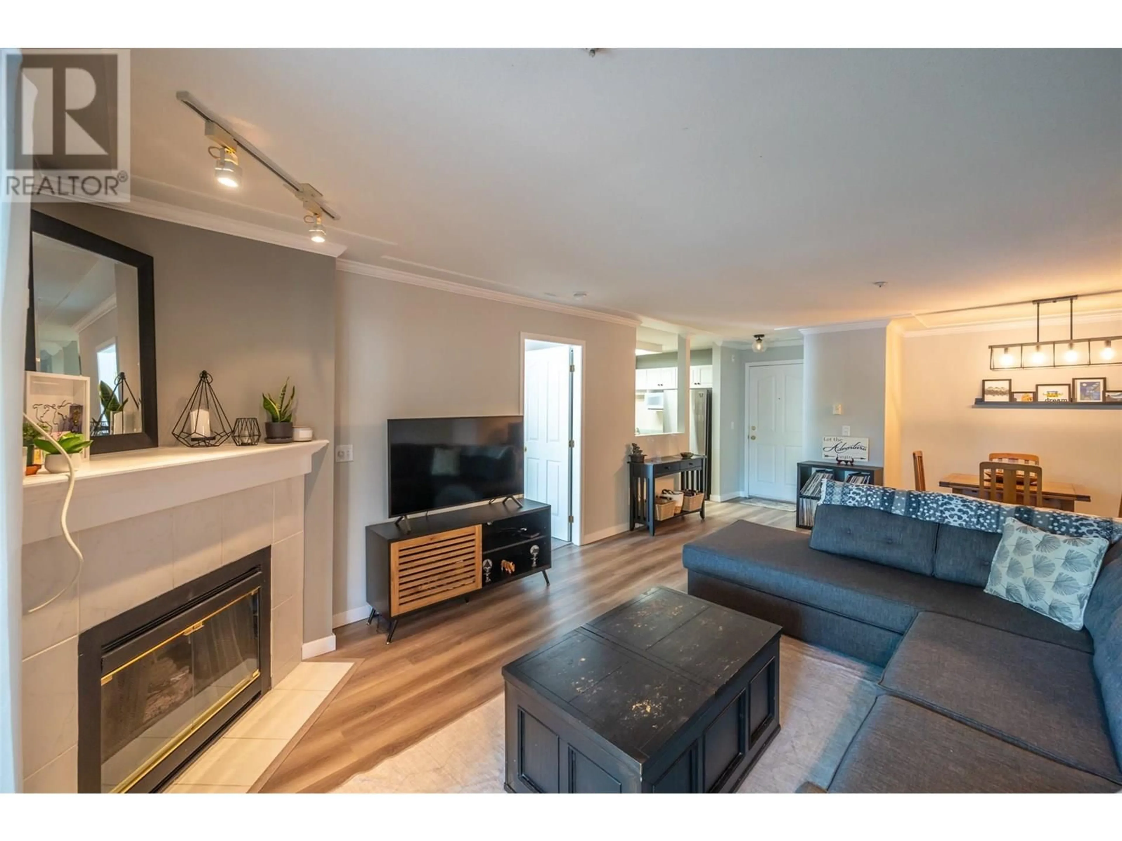 Living room with furniture, wood/laminate floor for 109 - 329 RIGSBY STREET, Penticton British Columbia V2A5S6