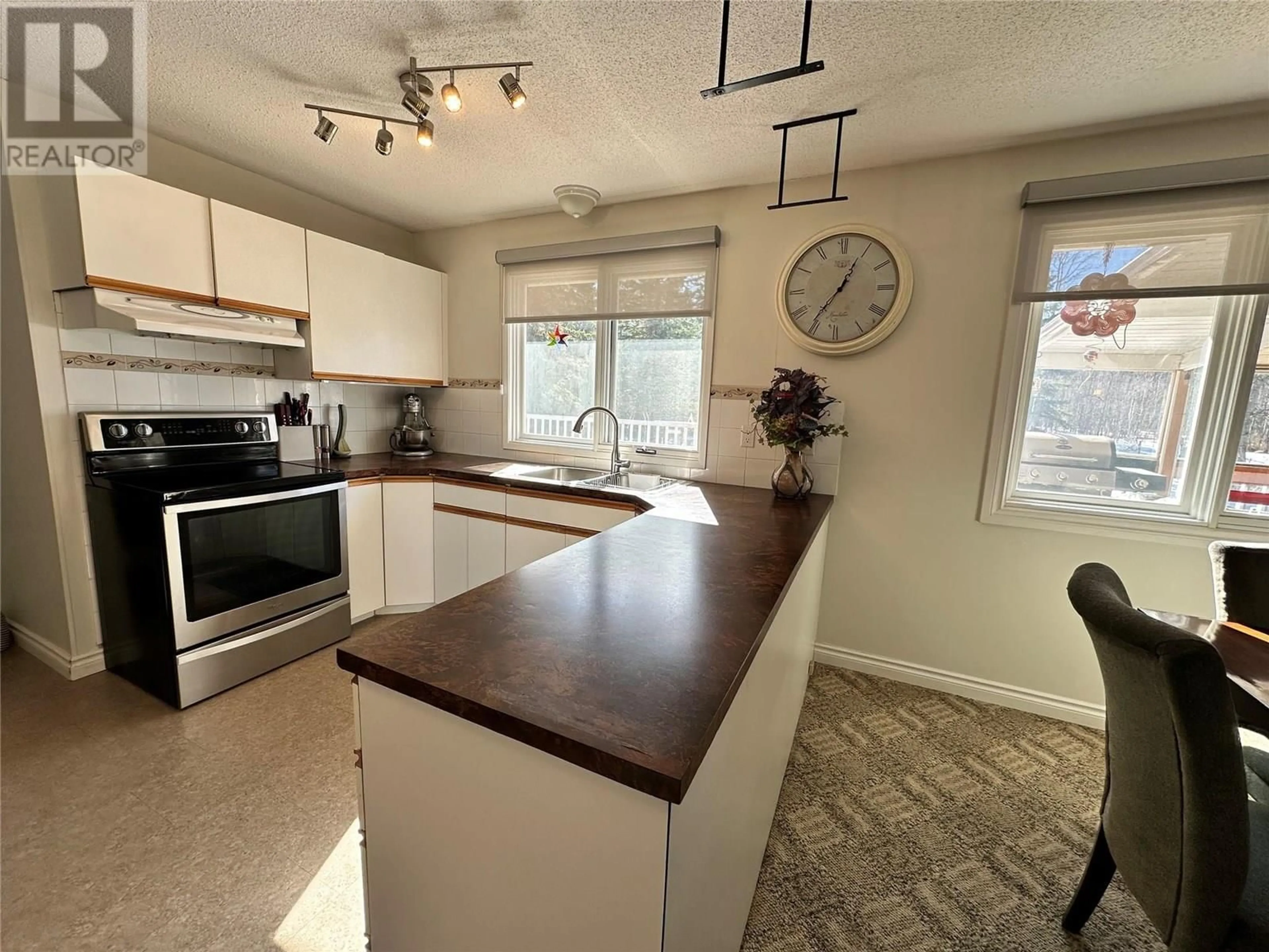 Open concept kitchen, wood/laminate floor for 13065 219 ROAD, Dawson Creek British Columbia V1G1C0