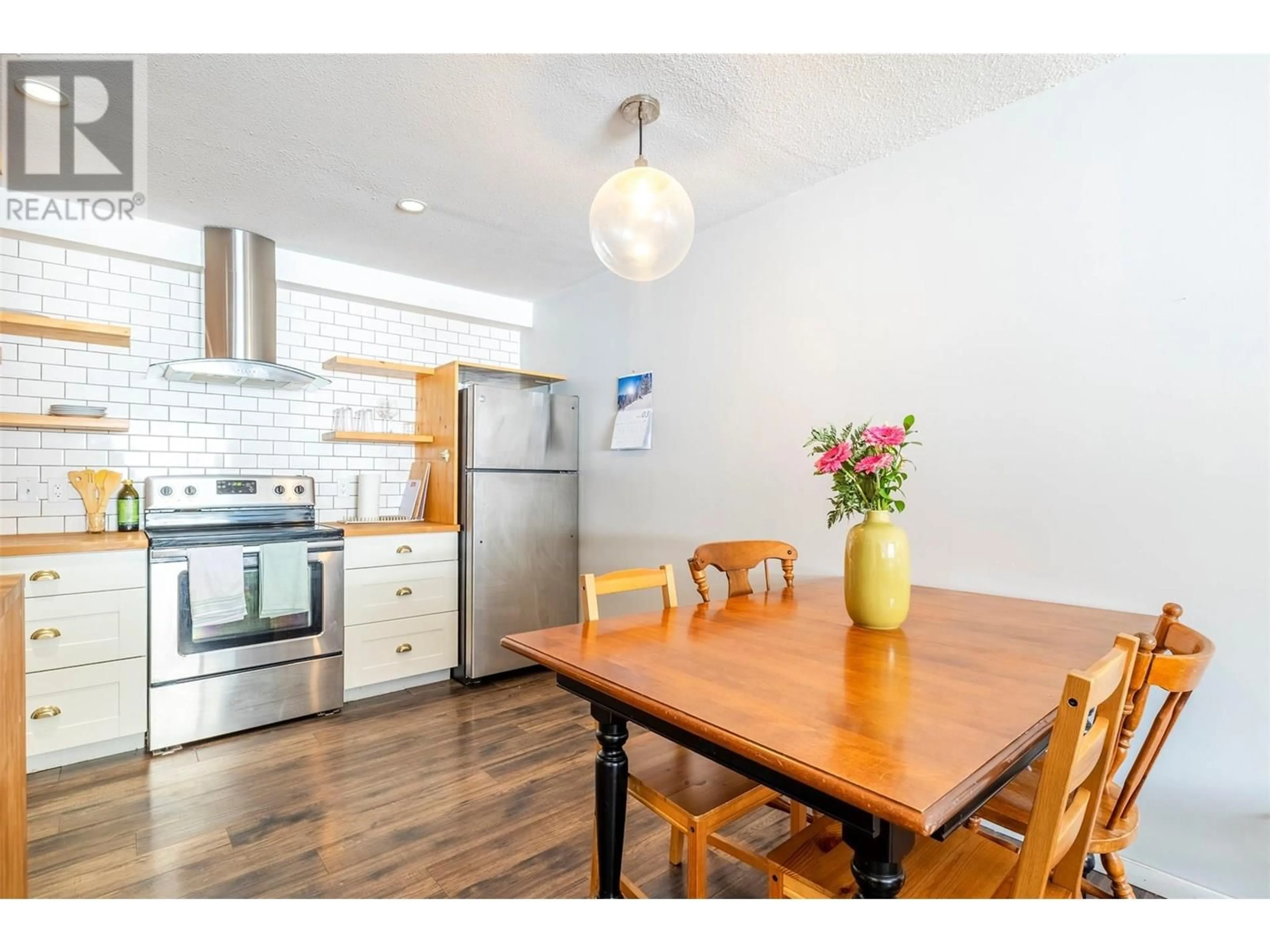 Open concept kitchen, wood/laminate floor for 103 - 30 RIDGEMONT AVENUE, Fernie British Columbia V0B1M2