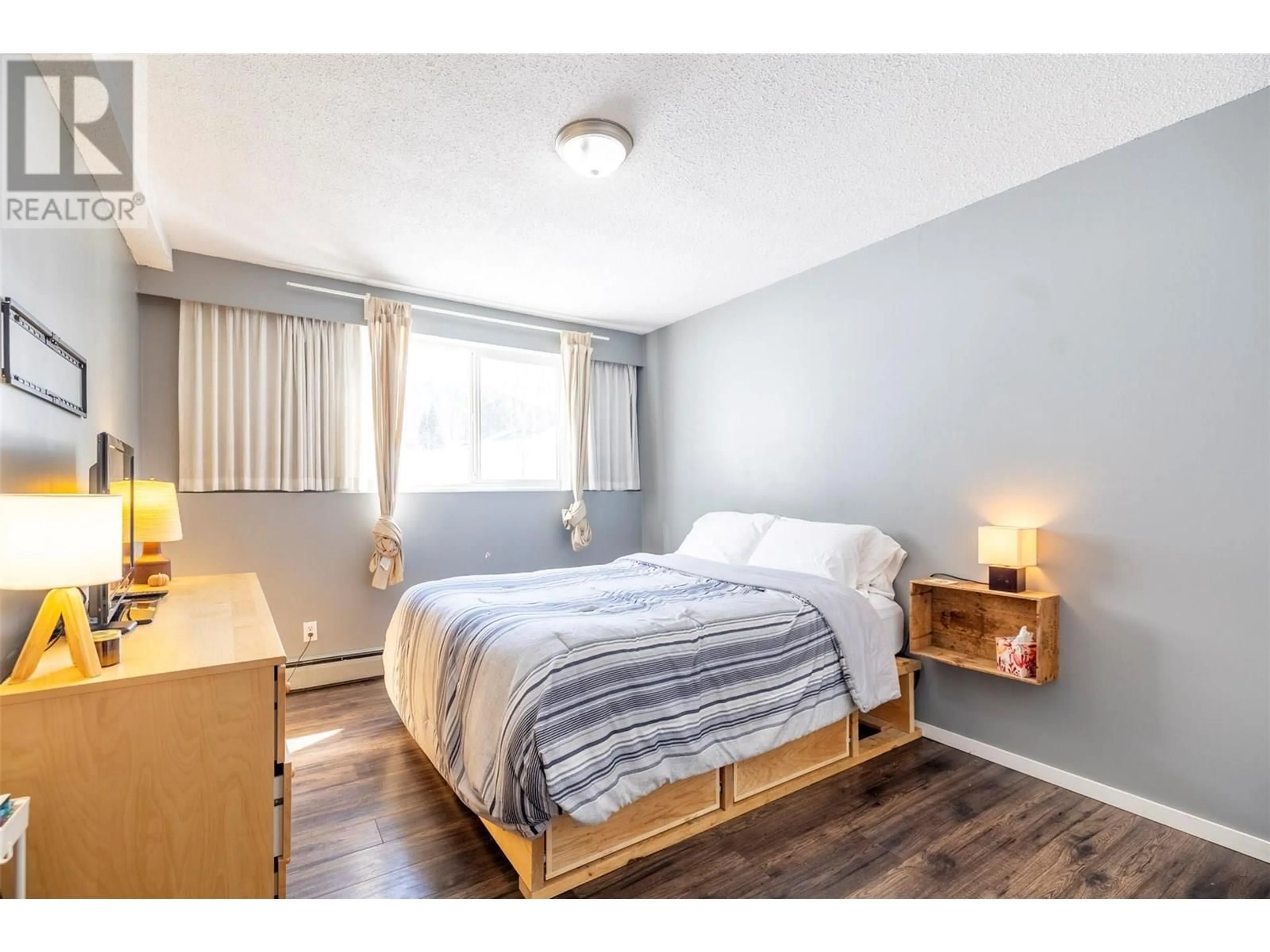 Bedroom with bed, wood/laminate floor for 103 - 30 RIDGEMONT AVENUE, Fernie British Columbia V0B1M2