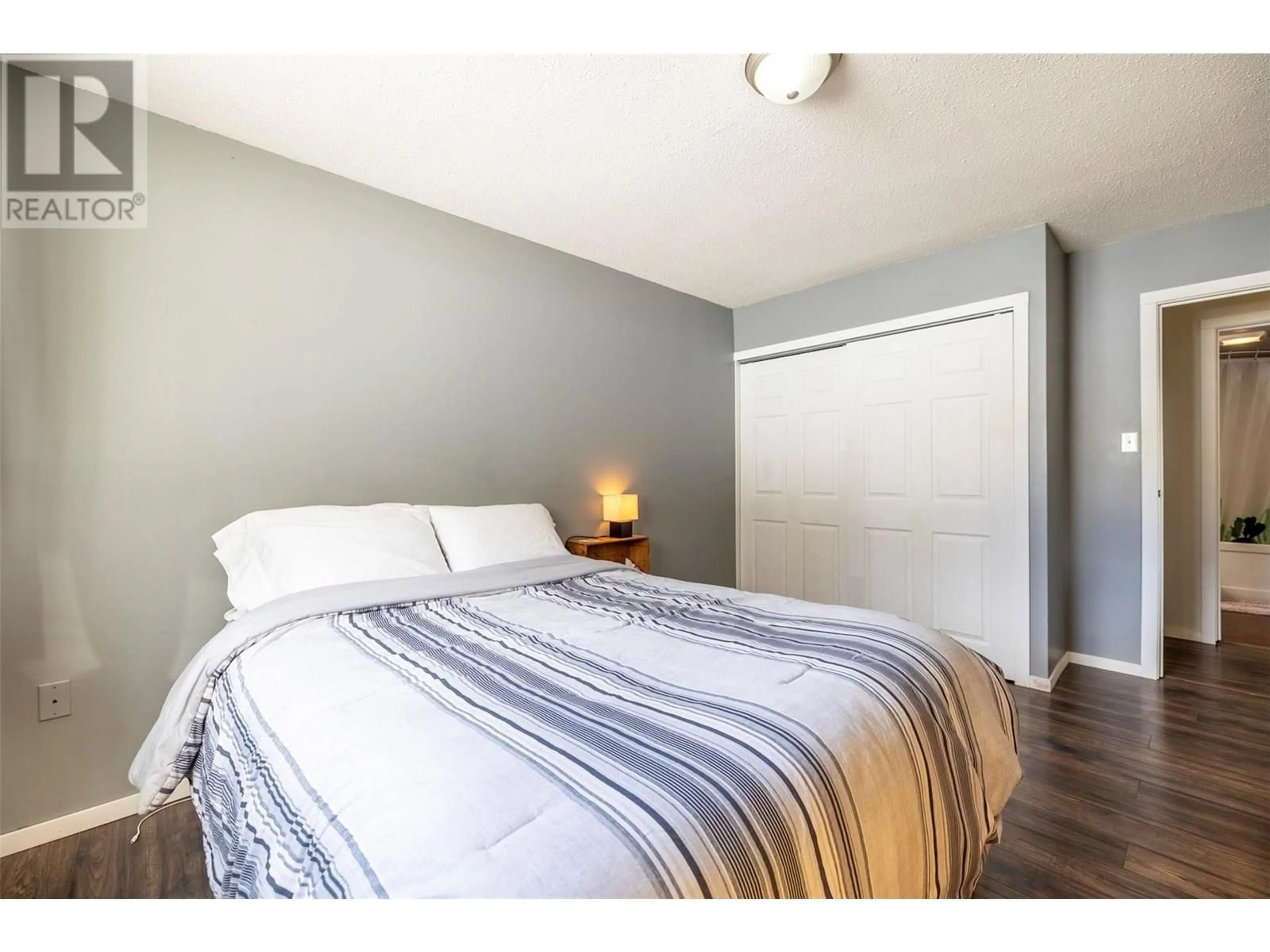 Bedroom with bed, wood/laminate floor for 103 - 30 RIDGEMONT AVENUE, Fernie British Columbia V0B1M2