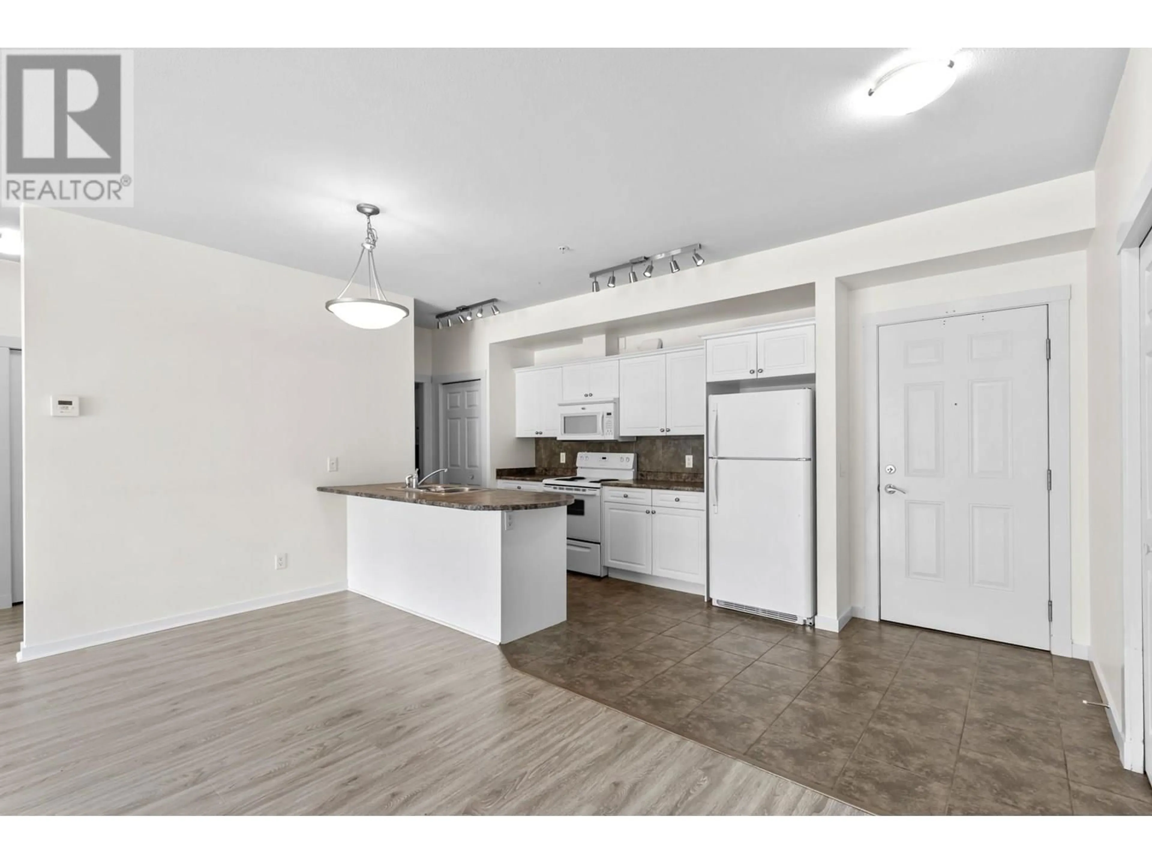Open concept kitchen, wood/laminate floor for 304 - 3550 WOODSDALE ROAD, Lake Country British Columbia V4V2P5