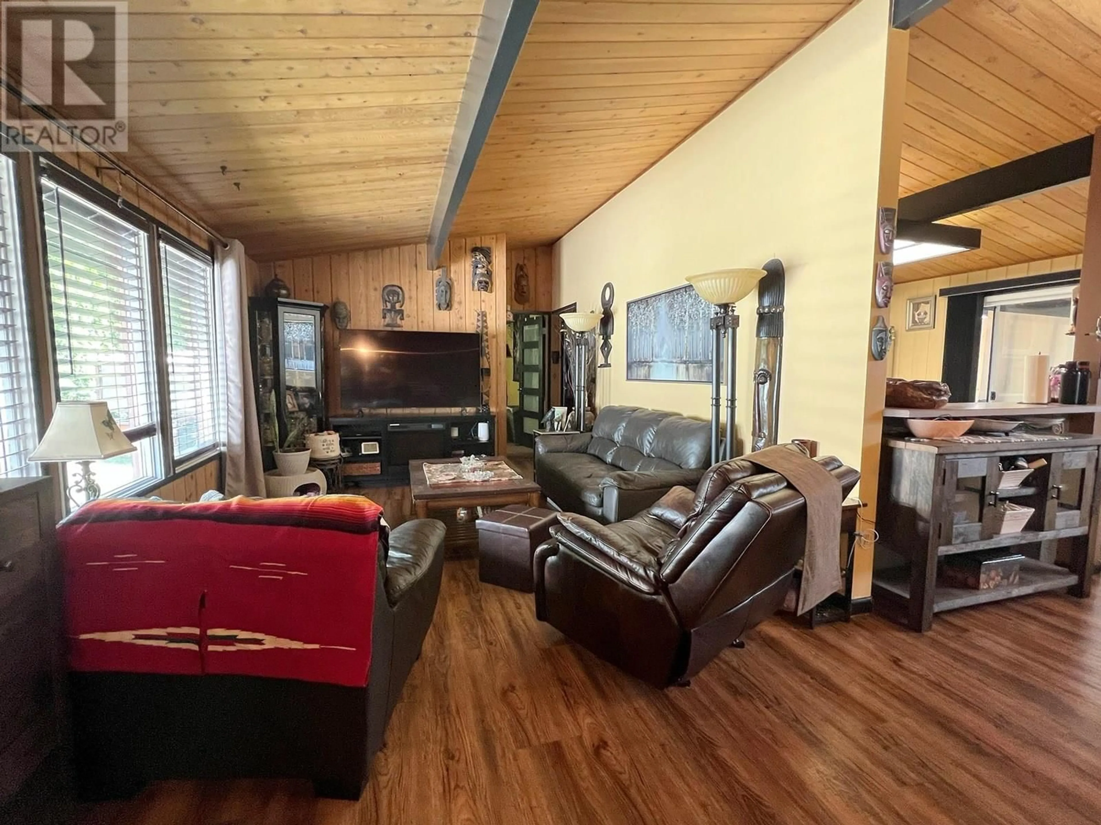 Living room with furniture, wood/laminate floor for 1490 HOLLYWOOD ROAD, Kelowna British Columbia V1X4N9