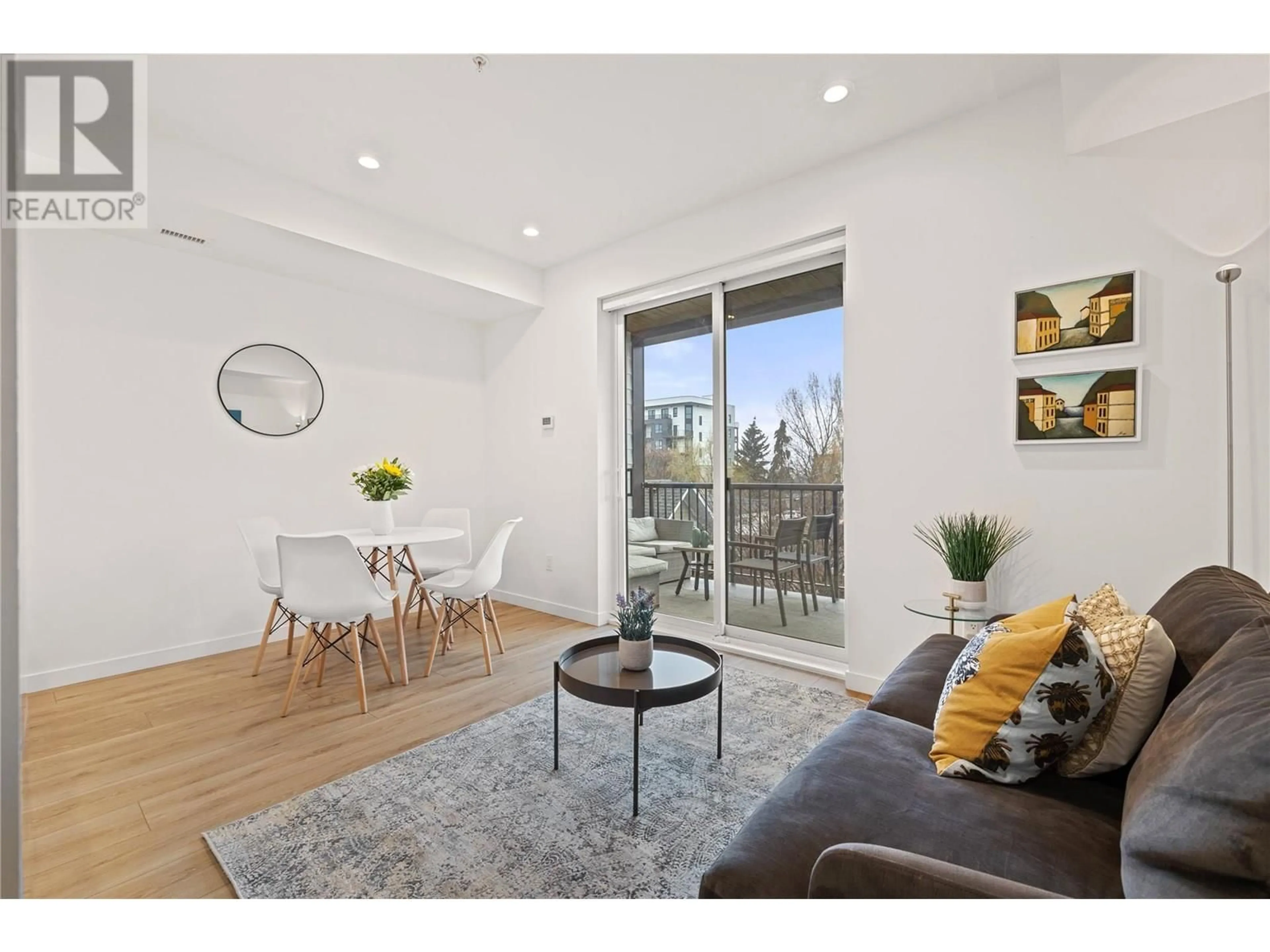 Living room with furniture, wood/laminate floor for 208 - 660 CAWSTON AVENUE, Kelowna British Columbia V1Y2L1