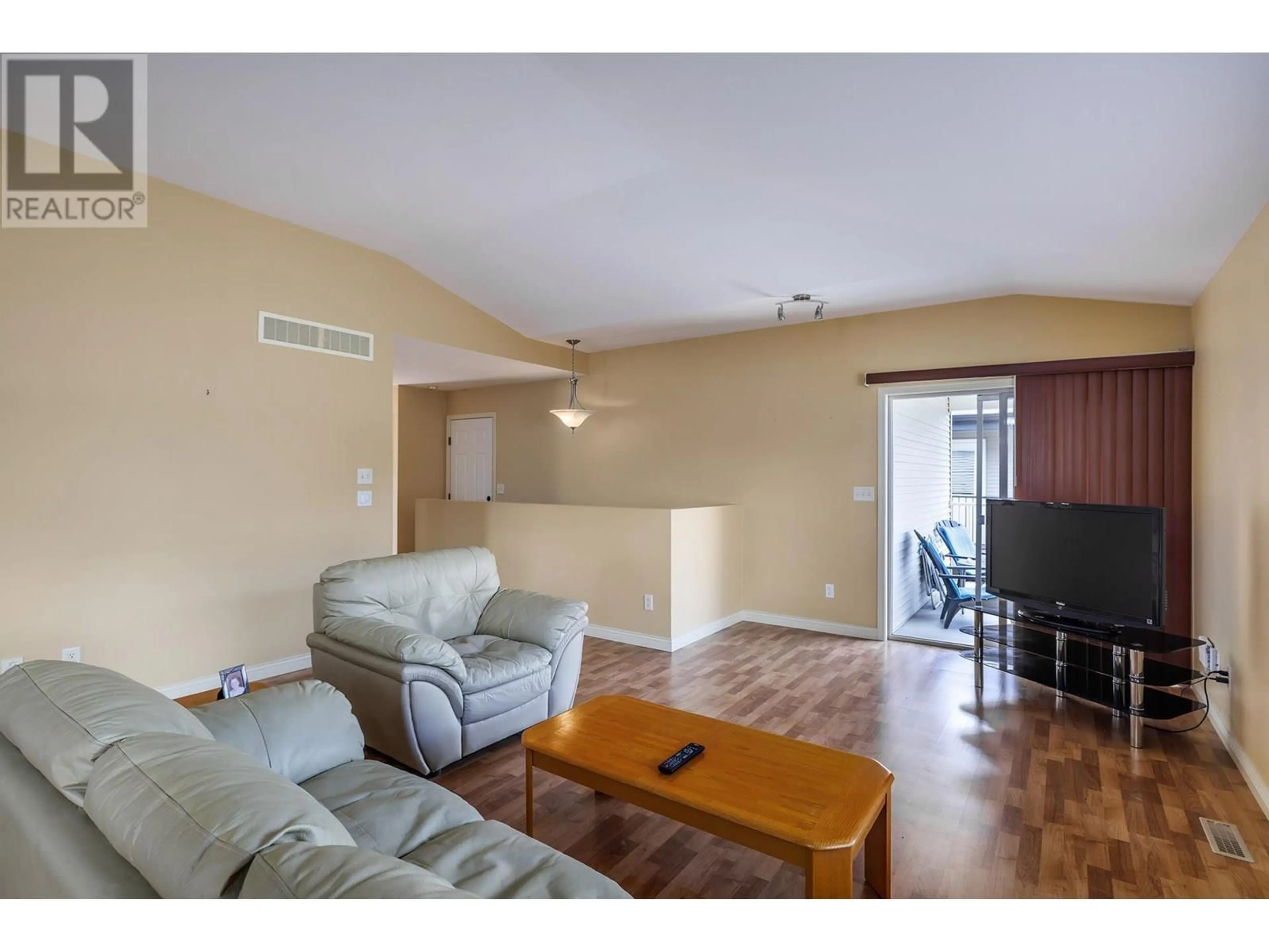 Living room with furniture, wood/laminate floor for 13 - 11392 LODGE ROAD, Lake Country British Columbia V4V1X2