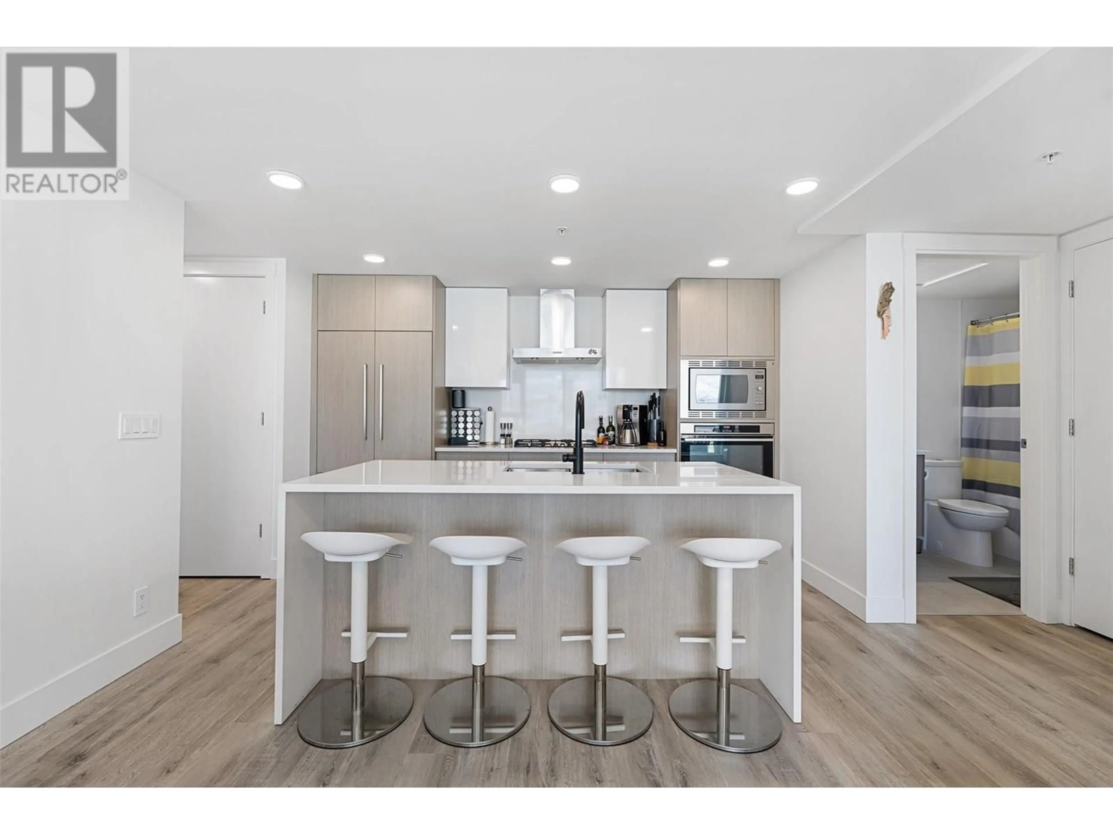 Open concept kitchen, wood/laminate floor for 1601 - 1588 ELLIS STREET, Kelowna British Columbia V1Y0H1