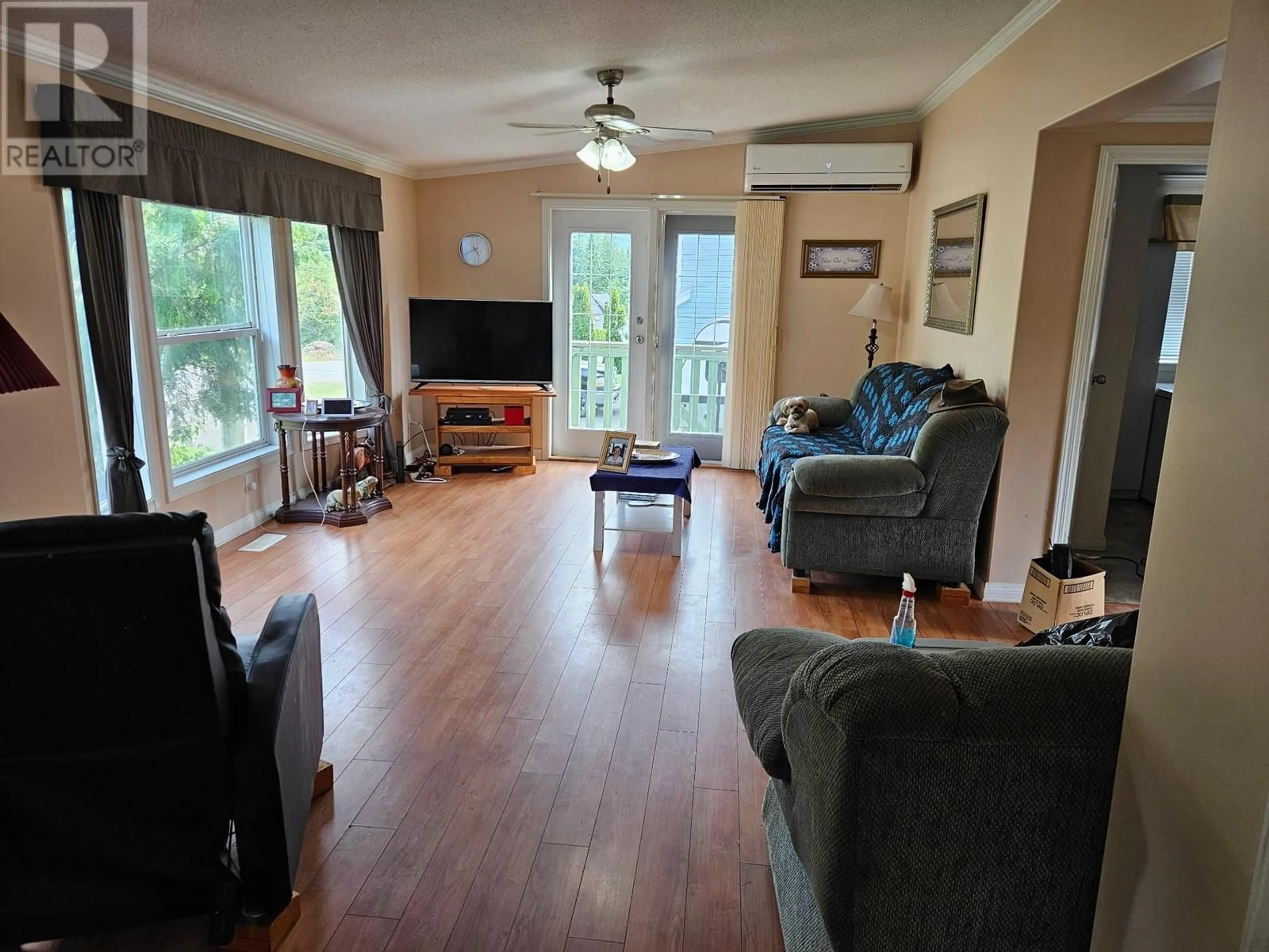 Living room with furniture, wood/laminate floor for 589 FAWN ROAD, 100 Mile House British Columbia V0E1N1