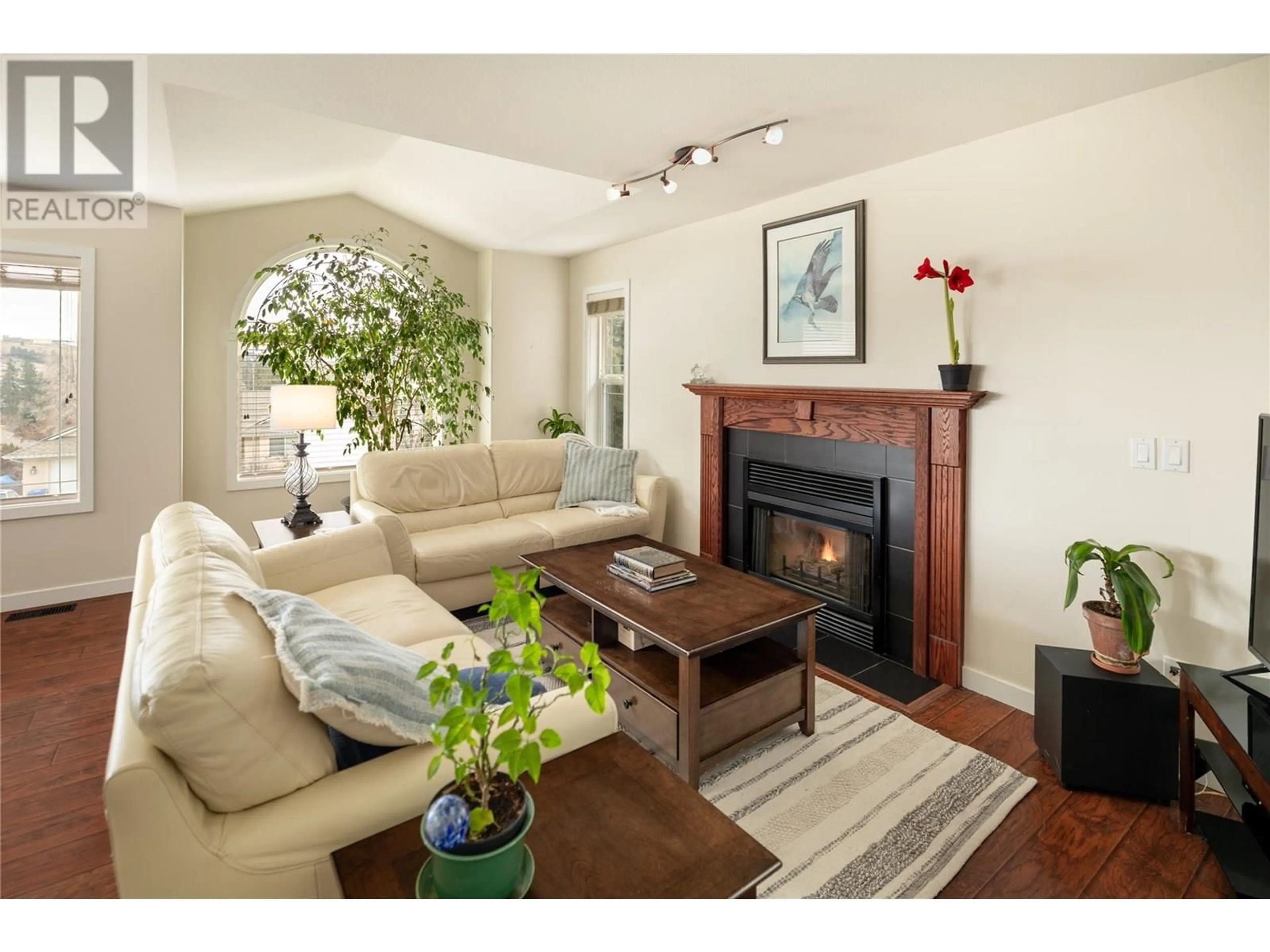 Living room with furniture, wood/laminate floor for 1068 CALEDONIA WAY, West Kelowna British Columbia V1Z3N7