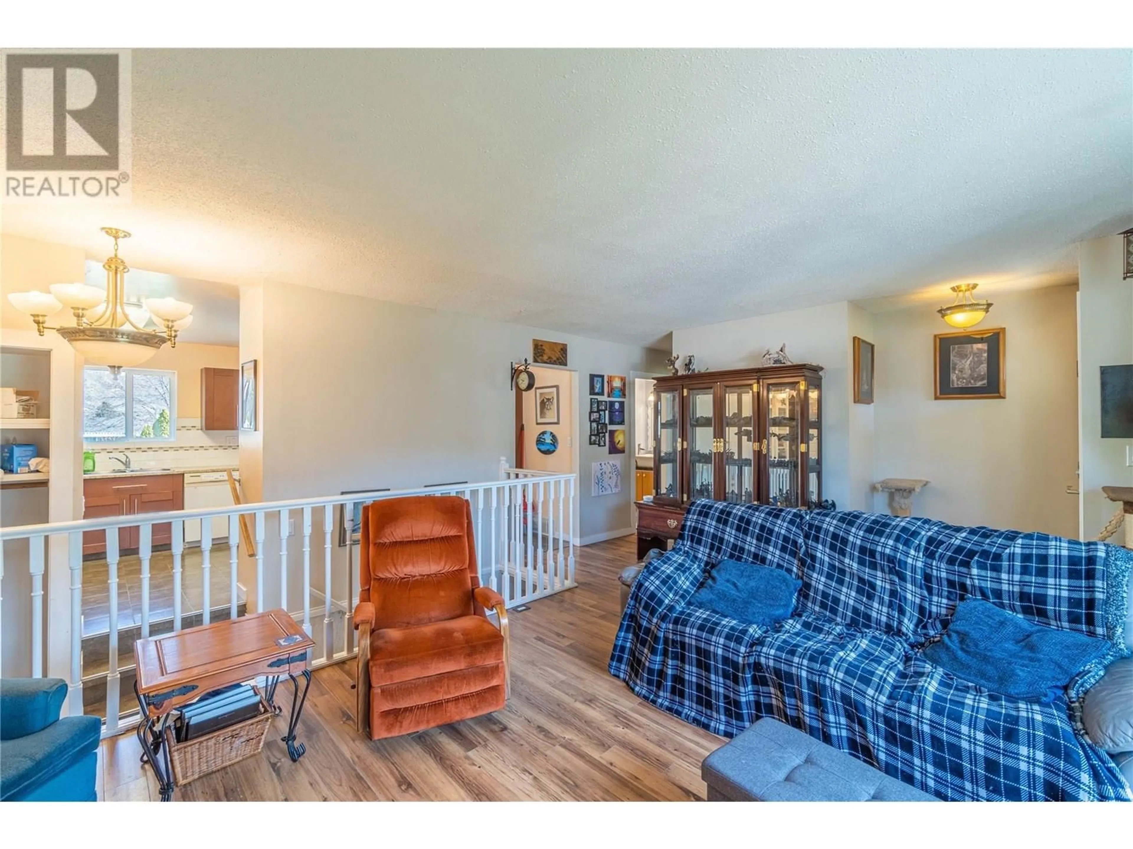 Living room with furniture, wood/laminate floor for 6418 FURRER ROAD, Kamloops British Columbia V2C4V6