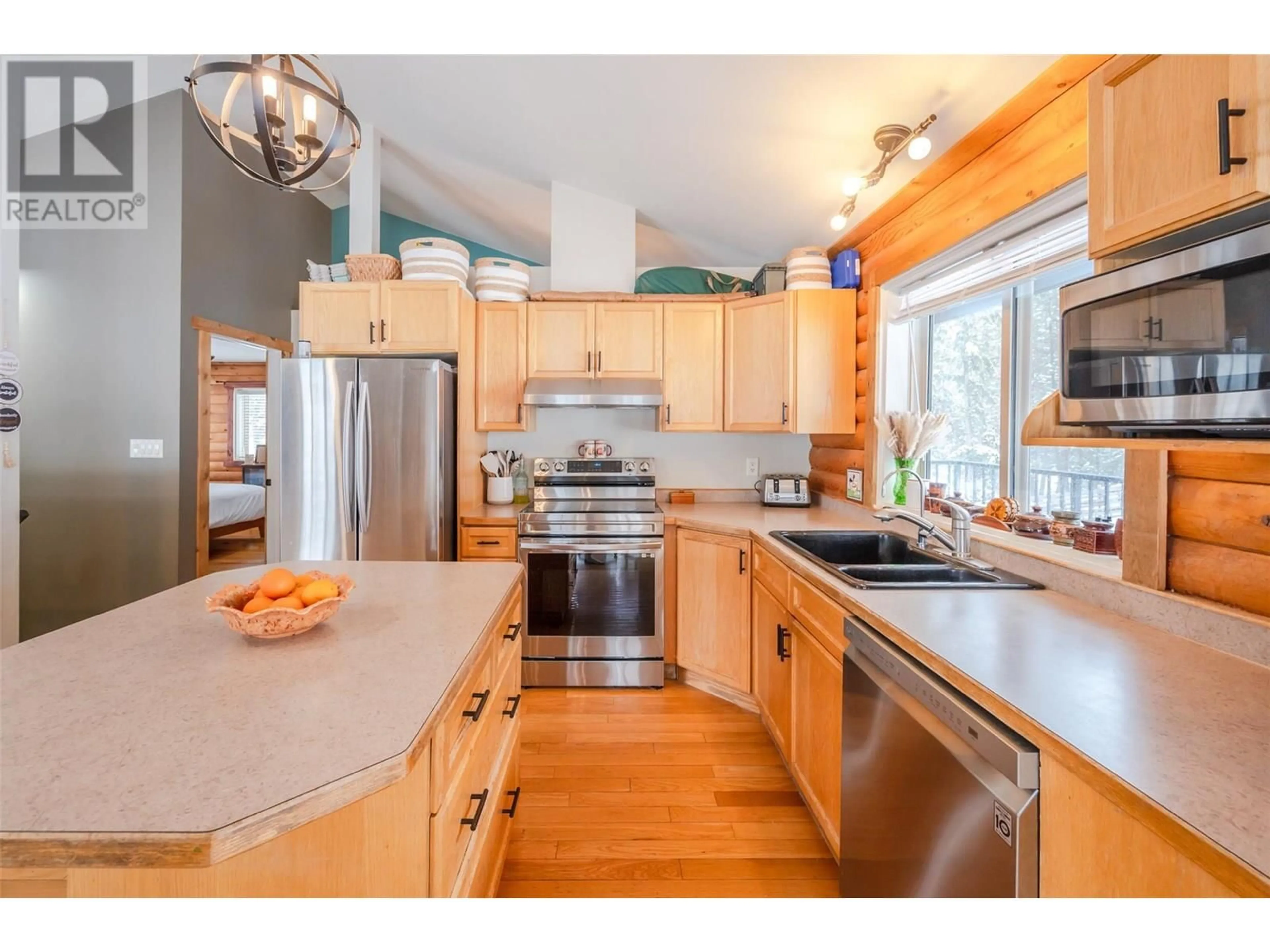 Open concept kitchen, wood/laminate floor for 105 SADDLEHORN DRIVE, Kaleden British Columbia V0H1K0