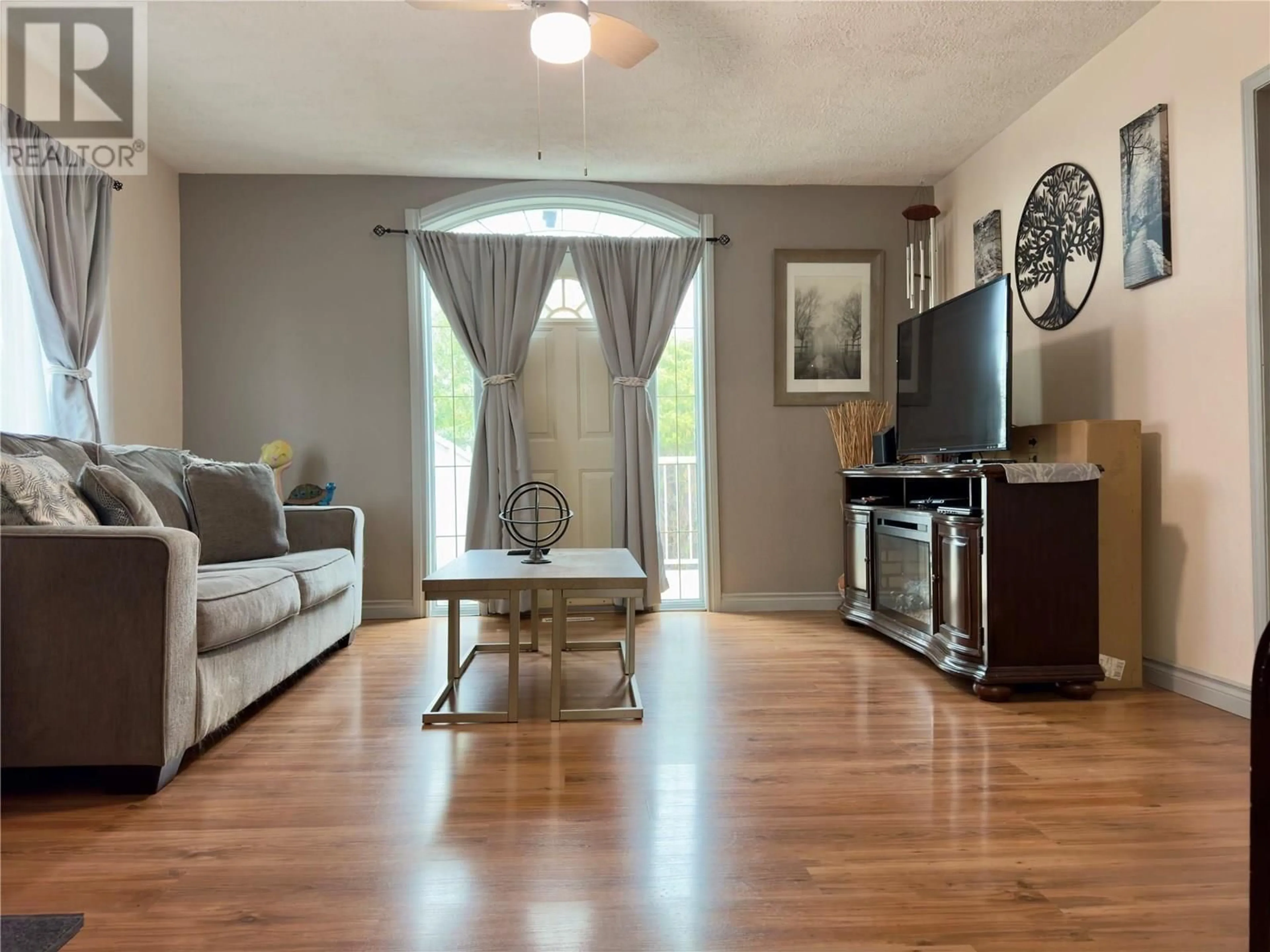 Living room with furniture, wood/laminate floor for 11604 10 STREET, Dawson Creek British Columbia V1G3V3