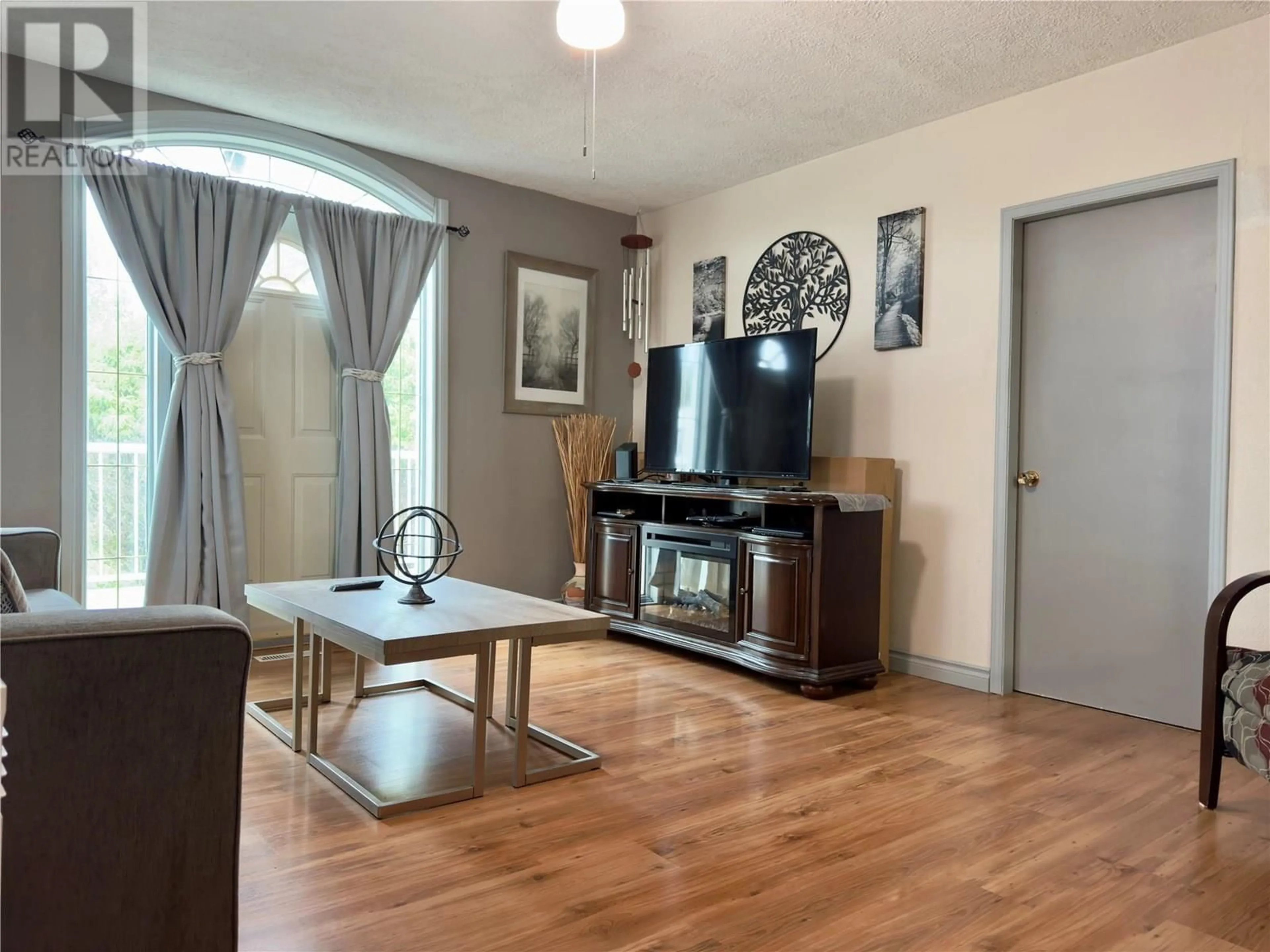 Living room with furniture, wood/laminate floor for 11604 10 STREET, Dawson Creek British Columbia V1G3V3