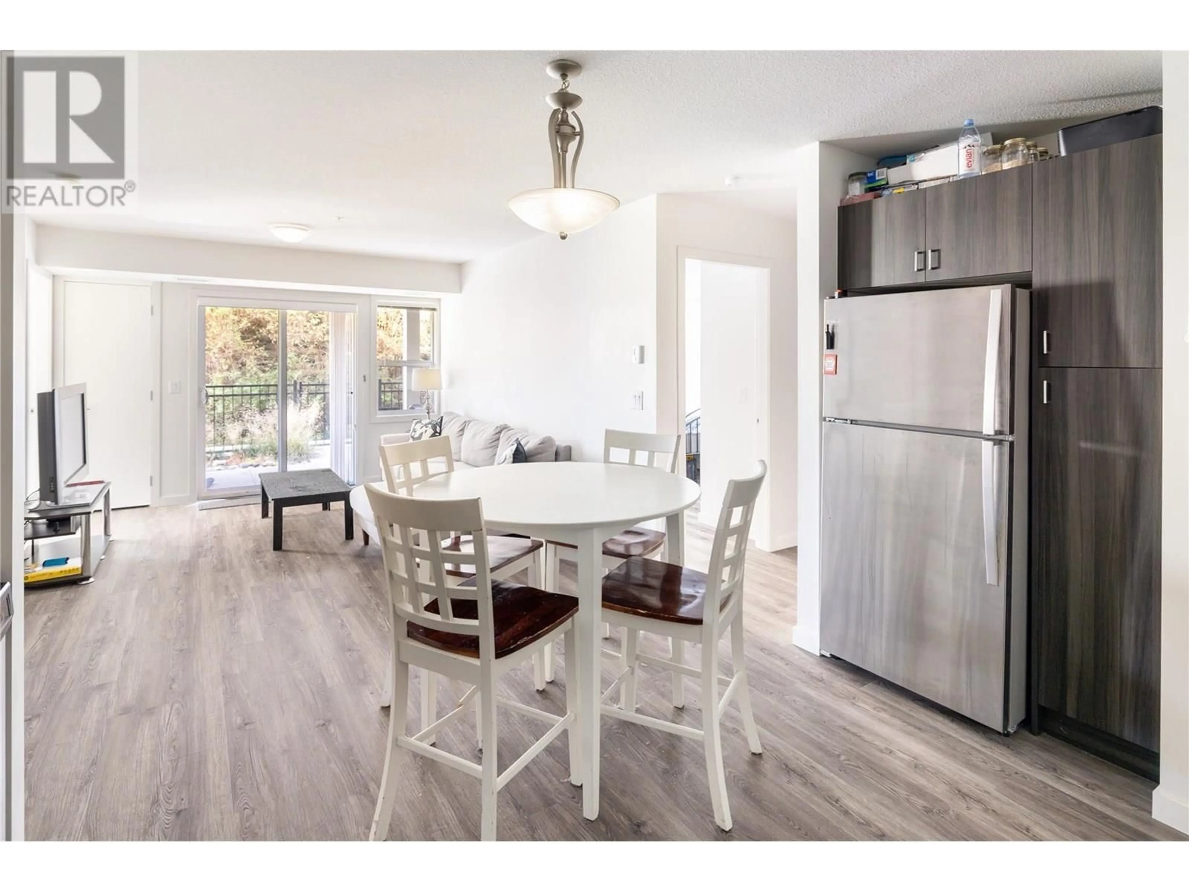 Open concept kitchen, wood/laminate floor for 107 - 655 ACADEMY WAY, Kelowna British Columbia V1V0C8